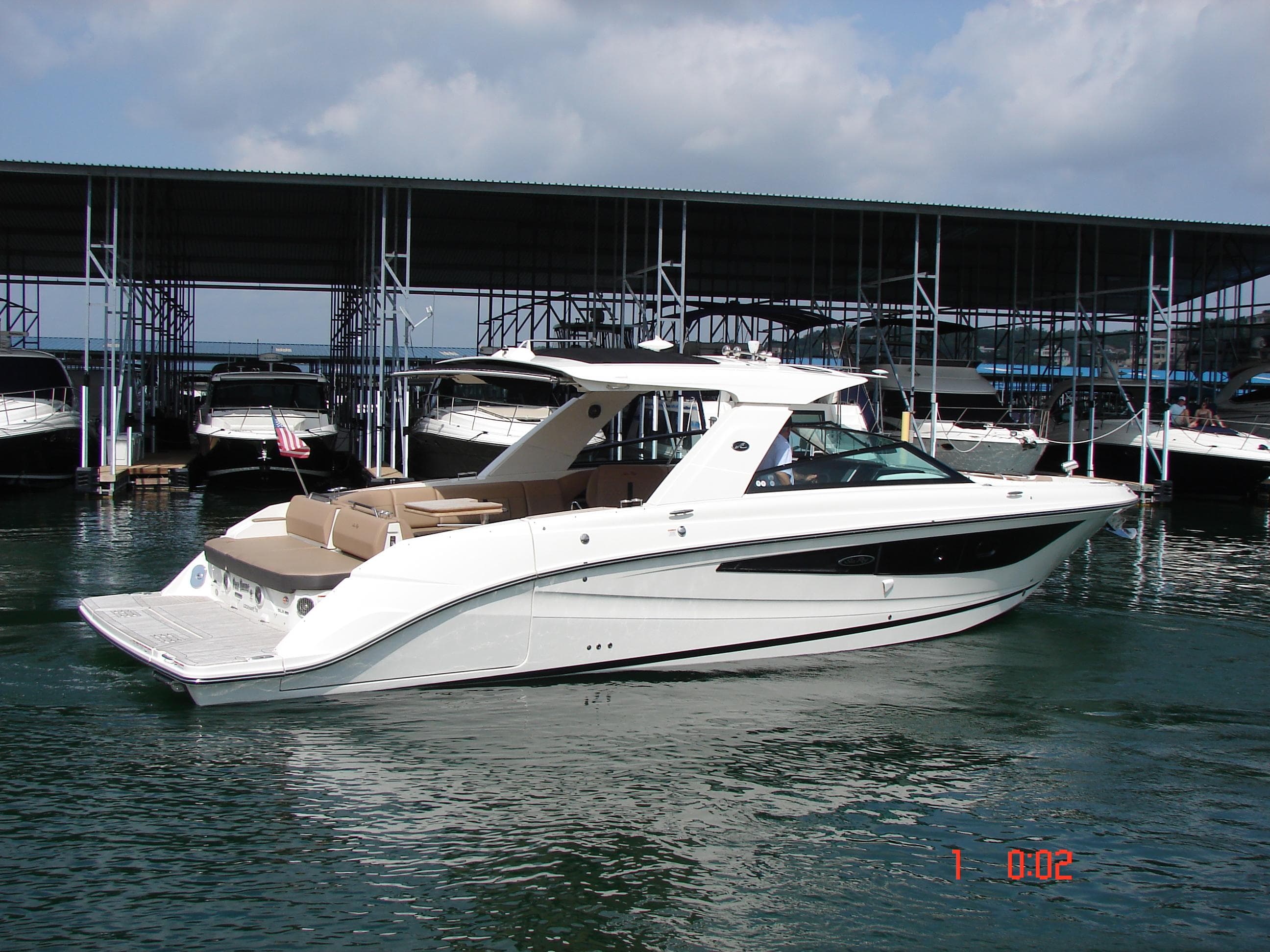 2018 Sea Ray SLX 400 boat docked in marina, featuring sleek design and spacious deck.
