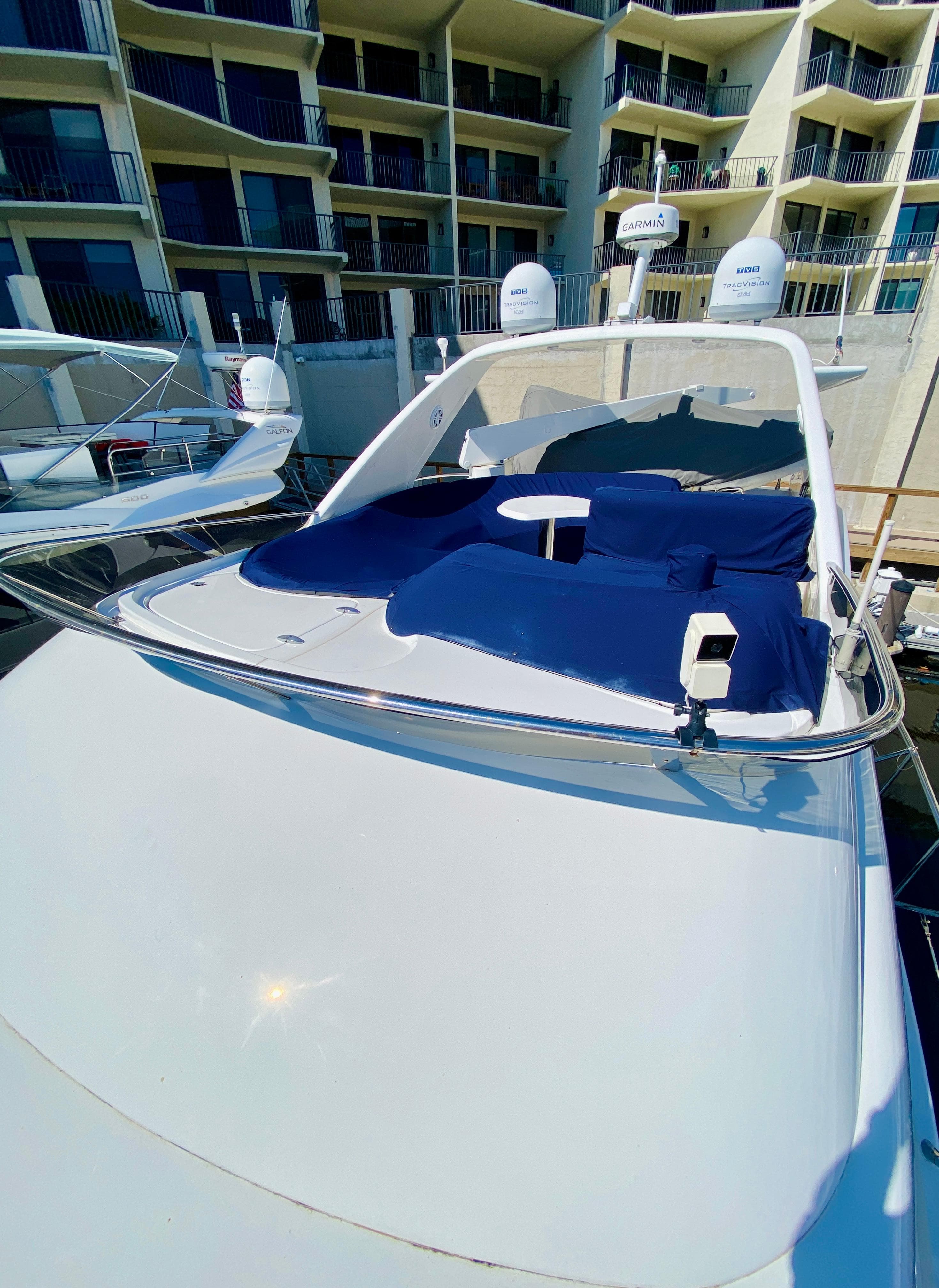 Azimut 55 yacht, 2002 model, docked with blue sunbathing area, modern design.