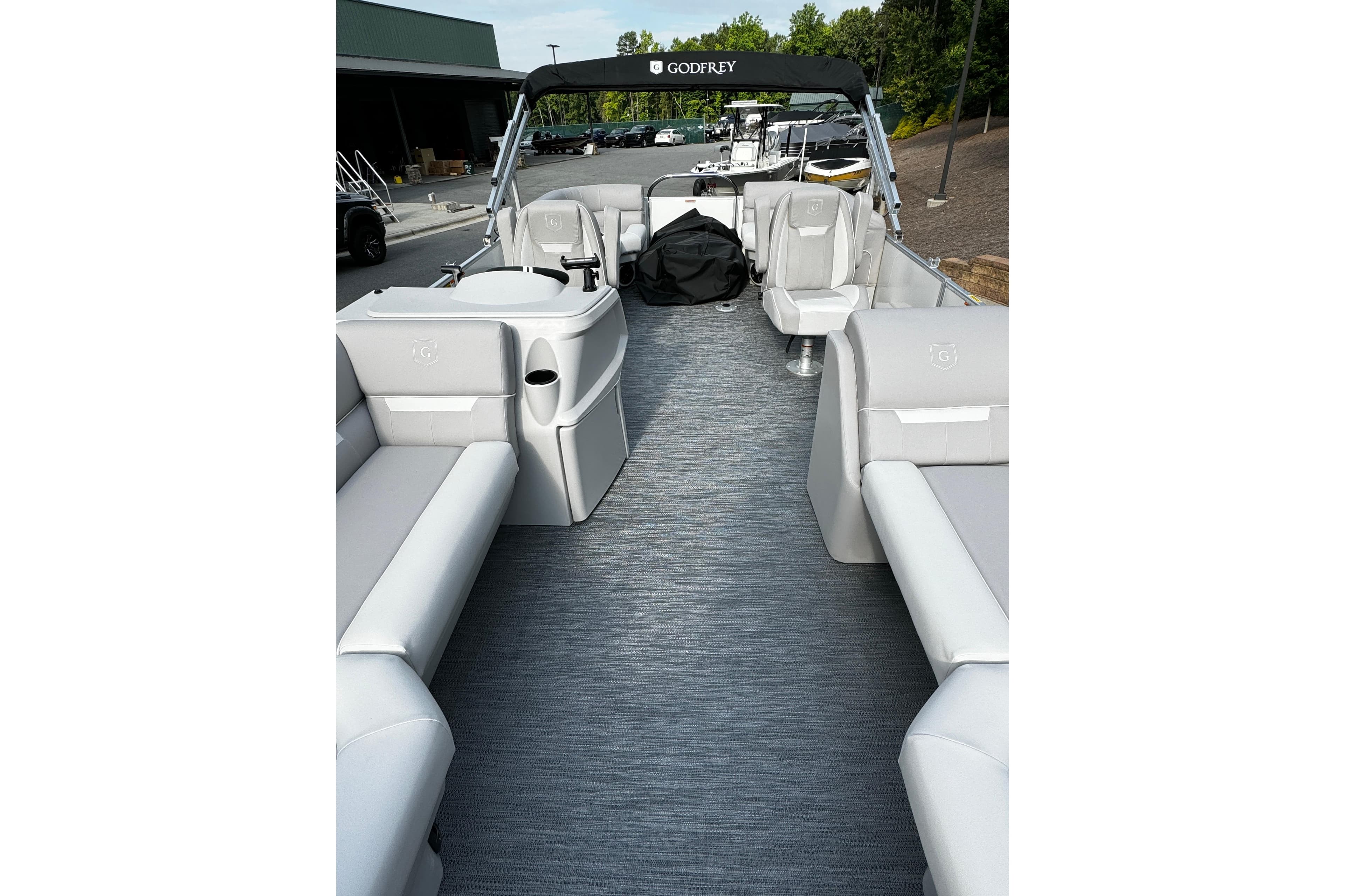2026 Godfrey Xperience 2286 SBX Sport Tube boat interior with gray seating and flooring.