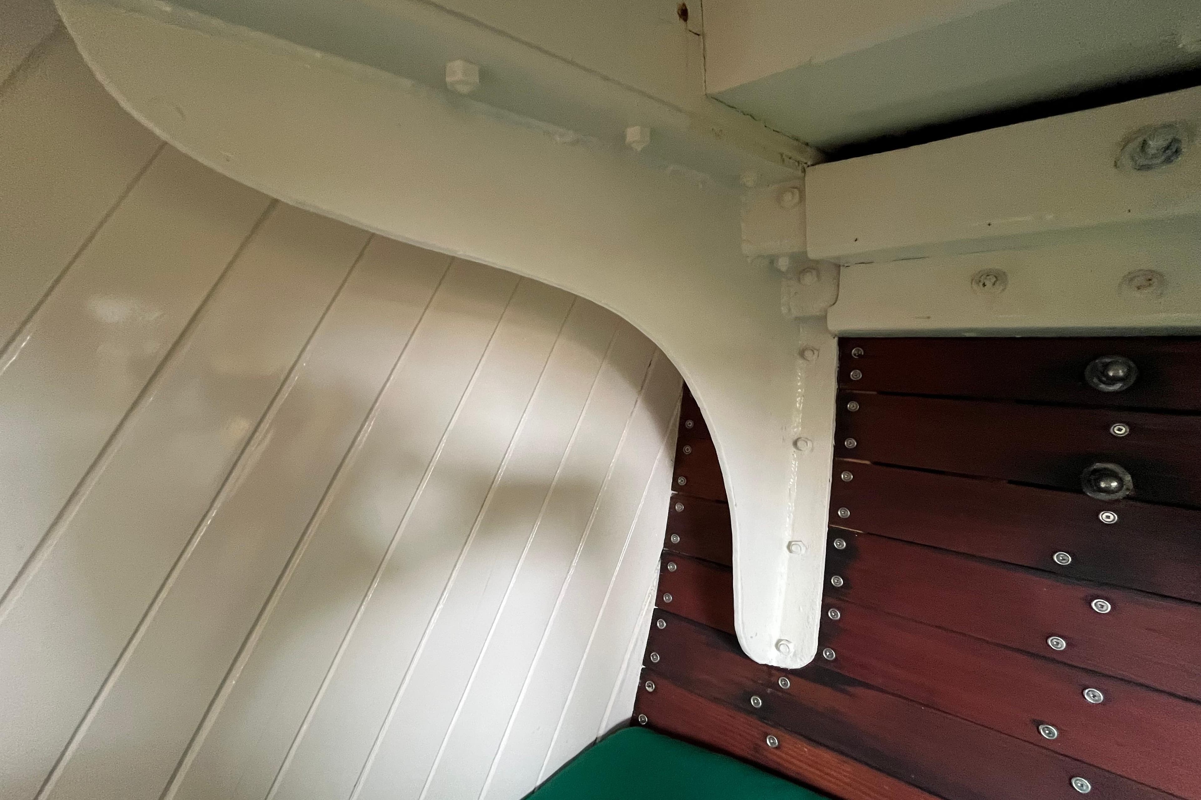 Interior detail of 1947 Murray Peterson Schooner, showcasing wooden paneling and structural elements.