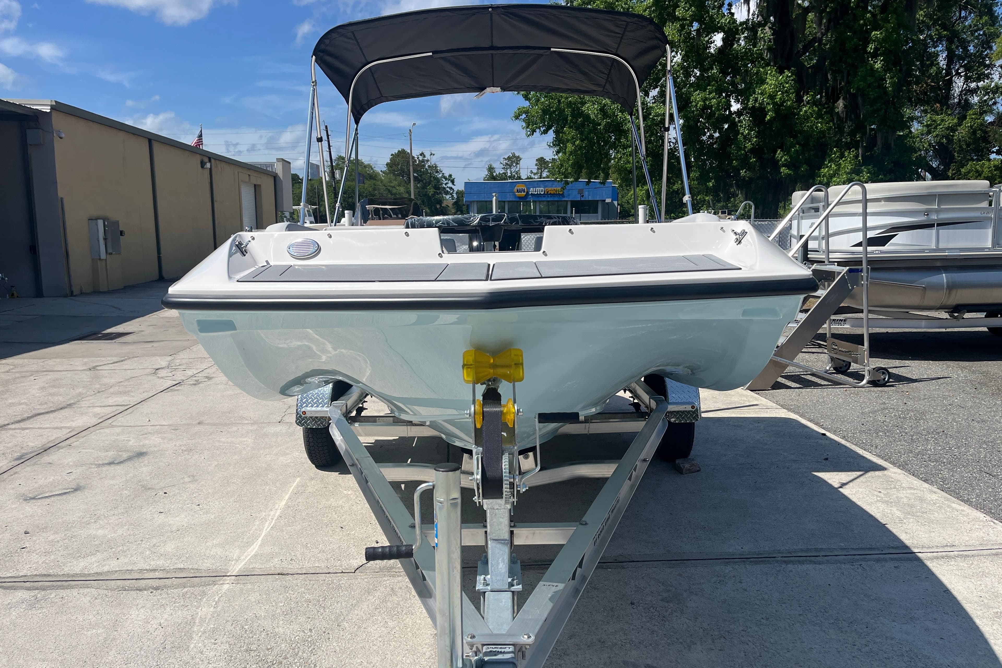2026 Starcraft SV 16 OB boat on trailer, parked outdoors under blue sky.