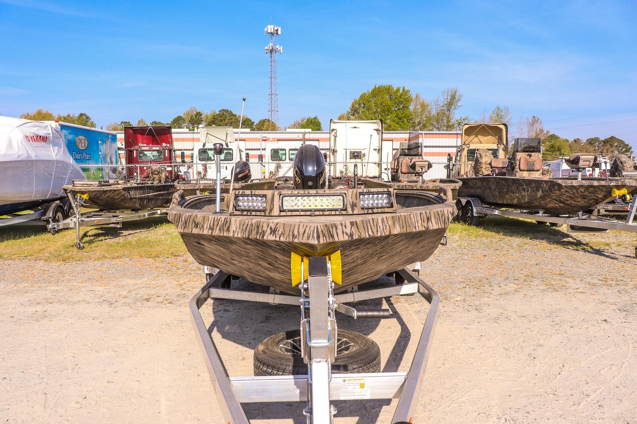 2026 Excel 183 Tomahawk boat on trailer in outdoor lot.