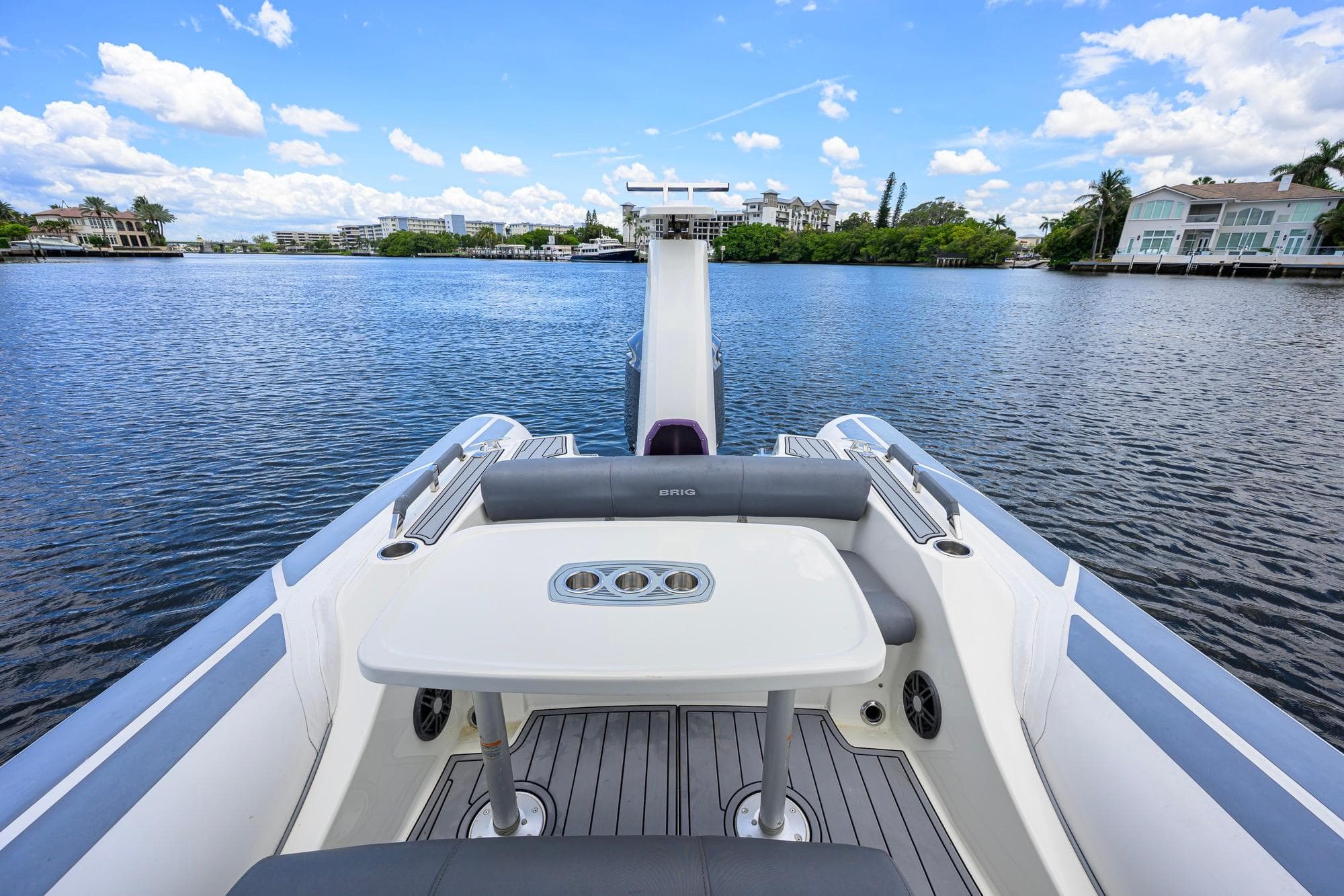 2021 Brig Eagle 8 boat interior with table, overlooking serene waterfront view.