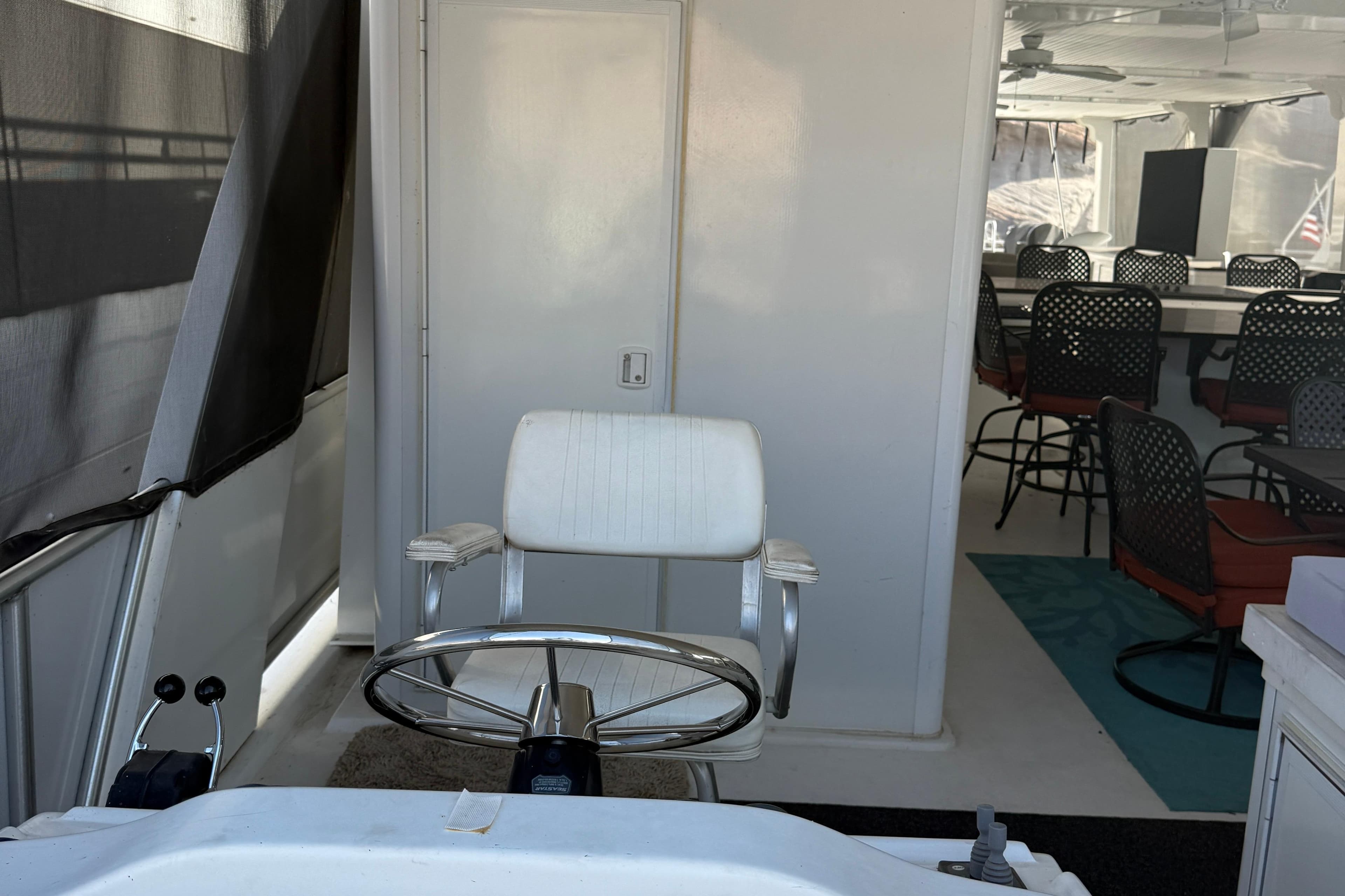 Interior of 2015 STARDUST Oceans Share #2 boat with seating and helm chair.