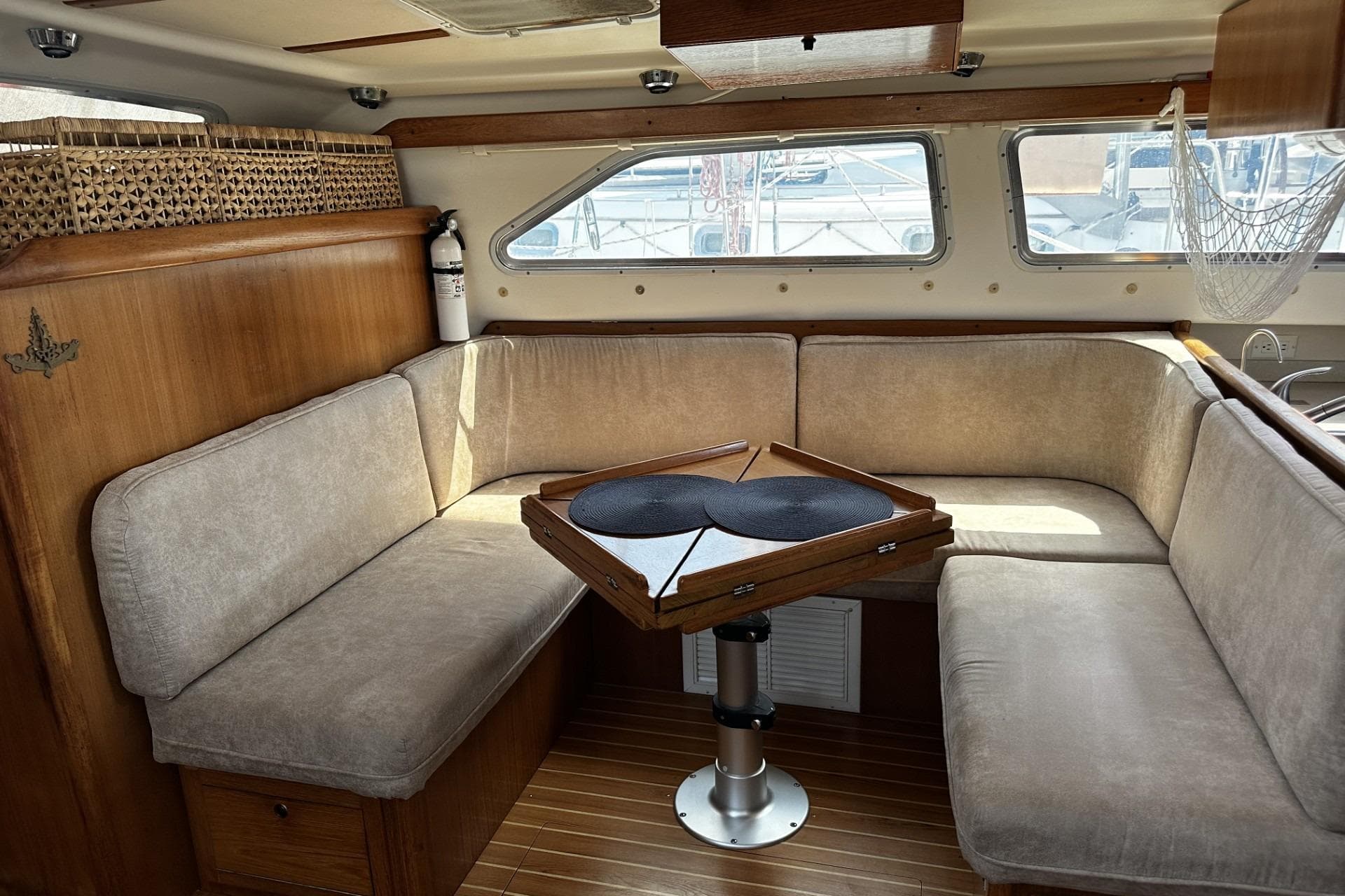 Interior of 2005 Catalina Morgan 440 yacht with cozy seating and wooden accents.