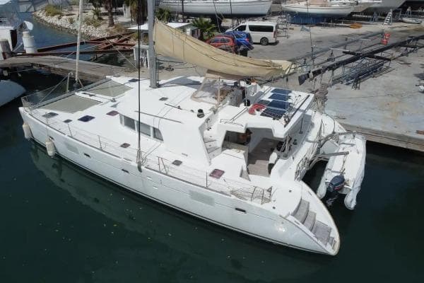 2007 Lagoon 500 catamaran docked at marina, featuring spacious deck and sails.