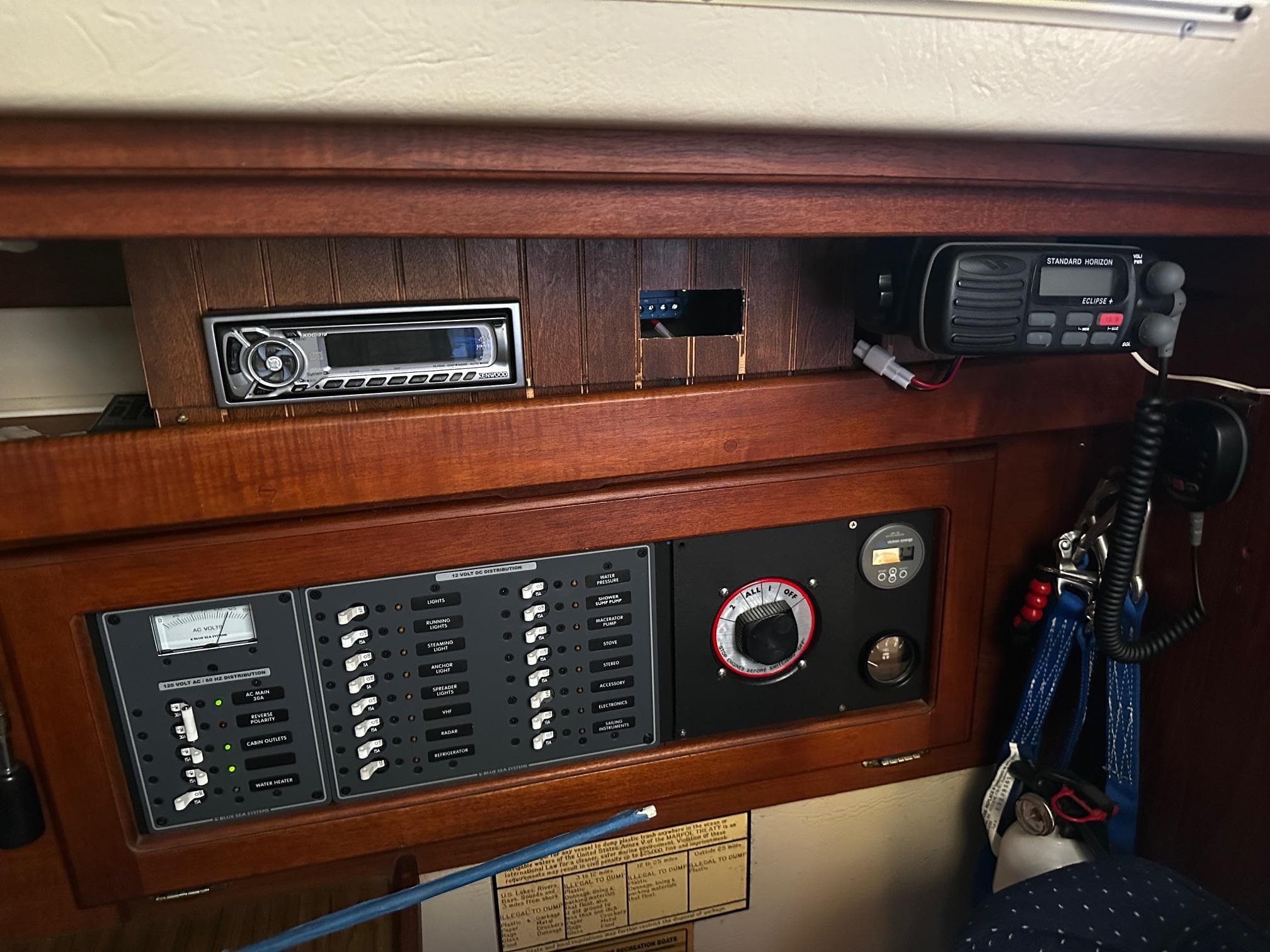 Control panel of a 1984 Catalina 36 Tall Rig sailboat with radio and gauges.