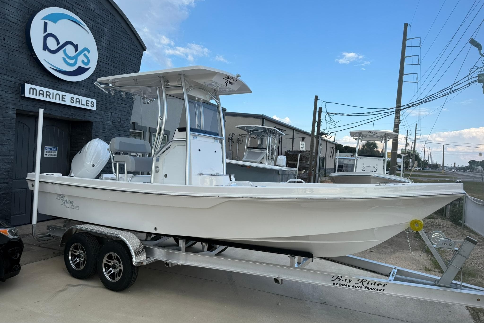 2026 Bay Rider 219 Bay boat on trailer at marine sales dealership.