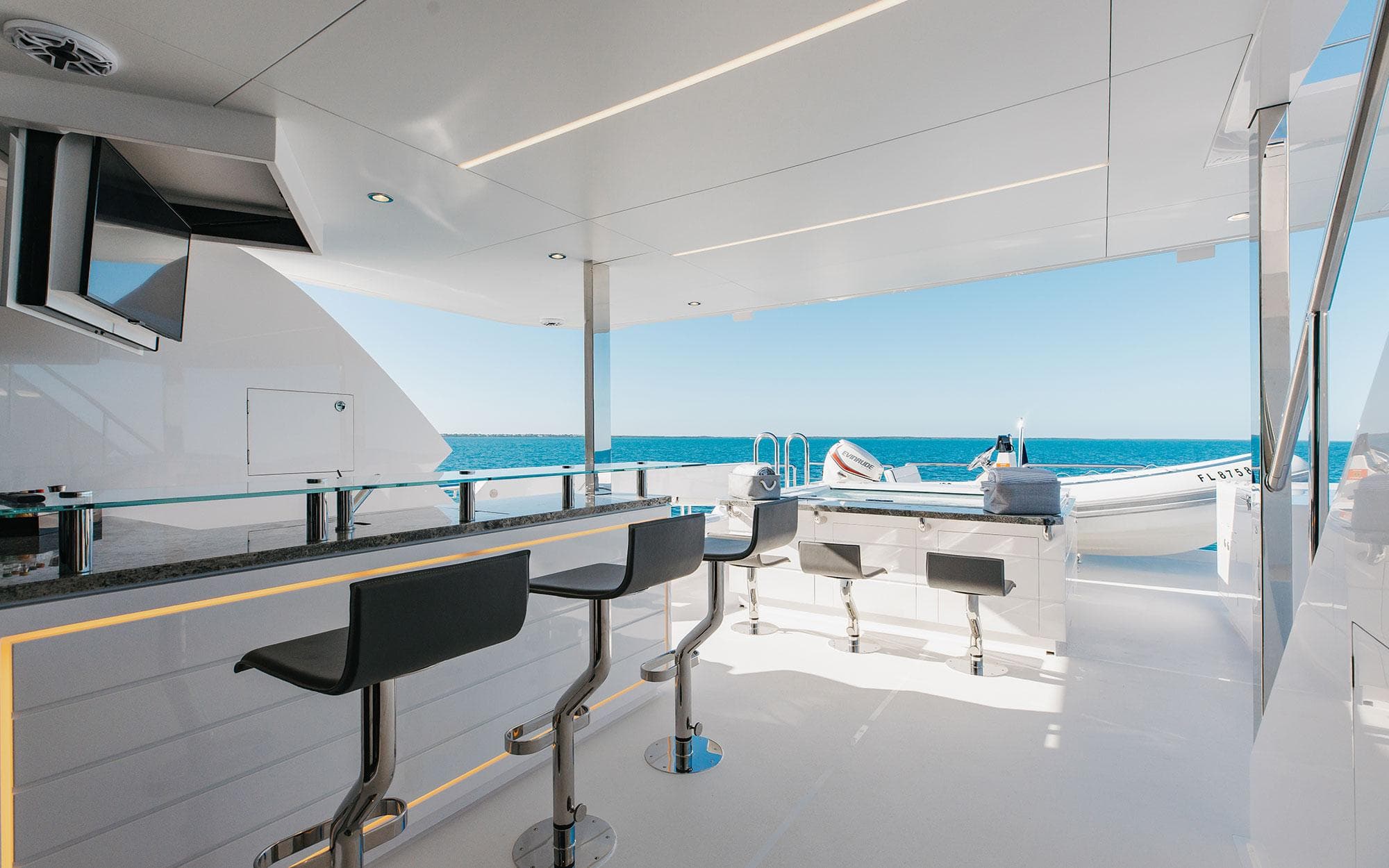 Luxurious Horizon FD 92 yacht deck with bar stools, ocean view, and modern design, 2022 model.
