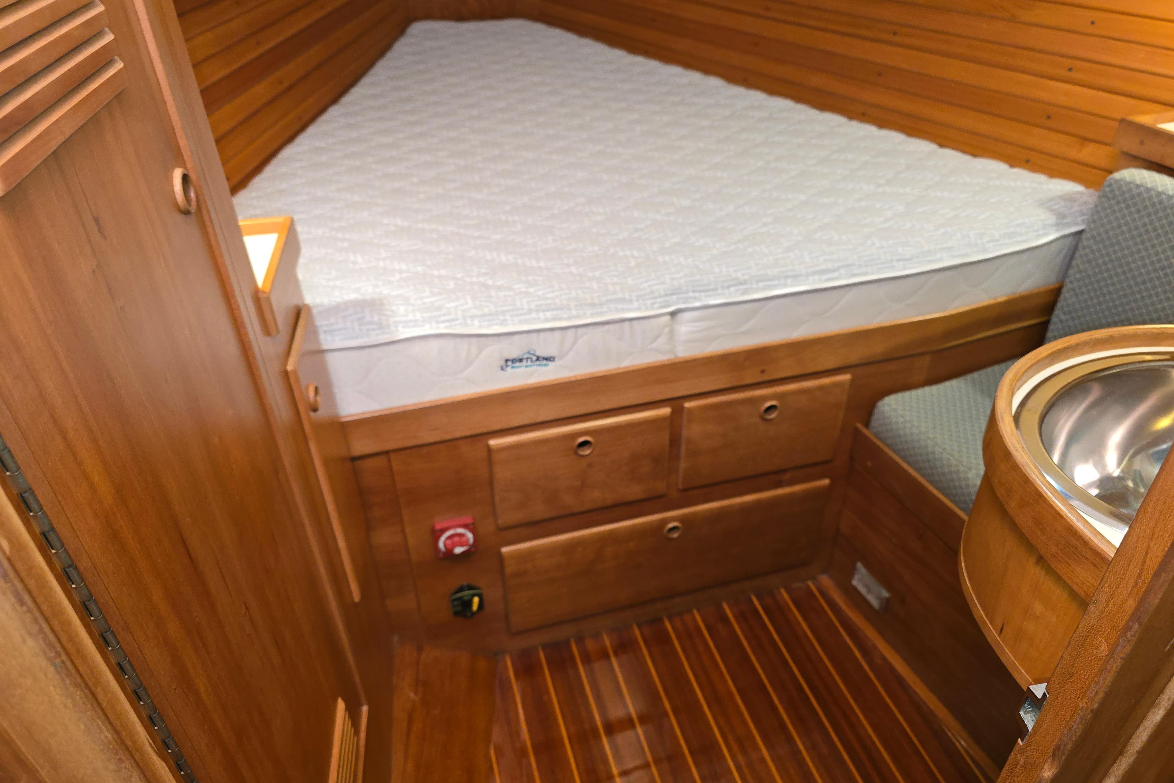 Cozy cabin interior of 1995 Sabre 36 yacht with wooden finish and compact sink.