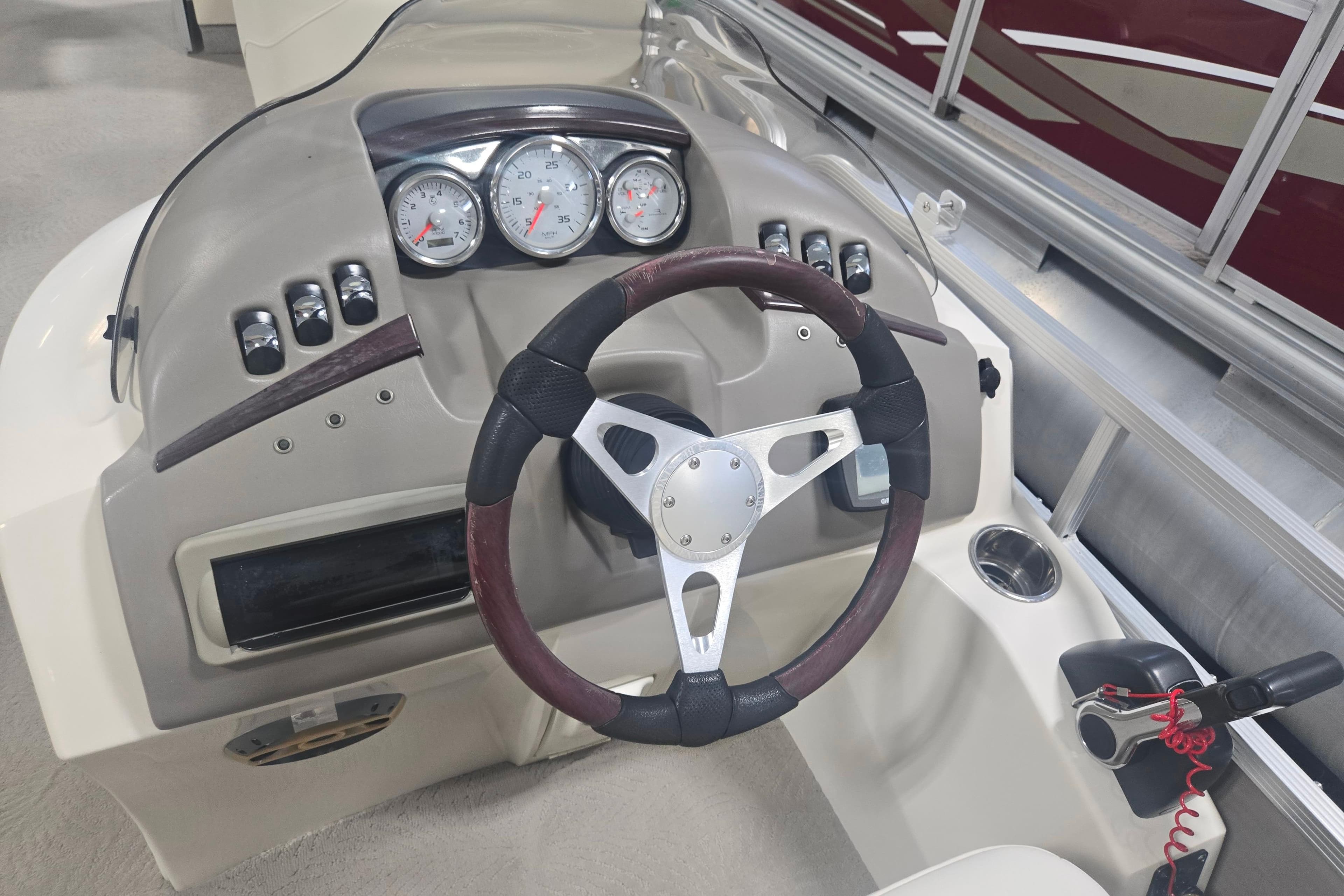 Steering console of a 2008 Bennington 2254RL boat with gauges and controls.