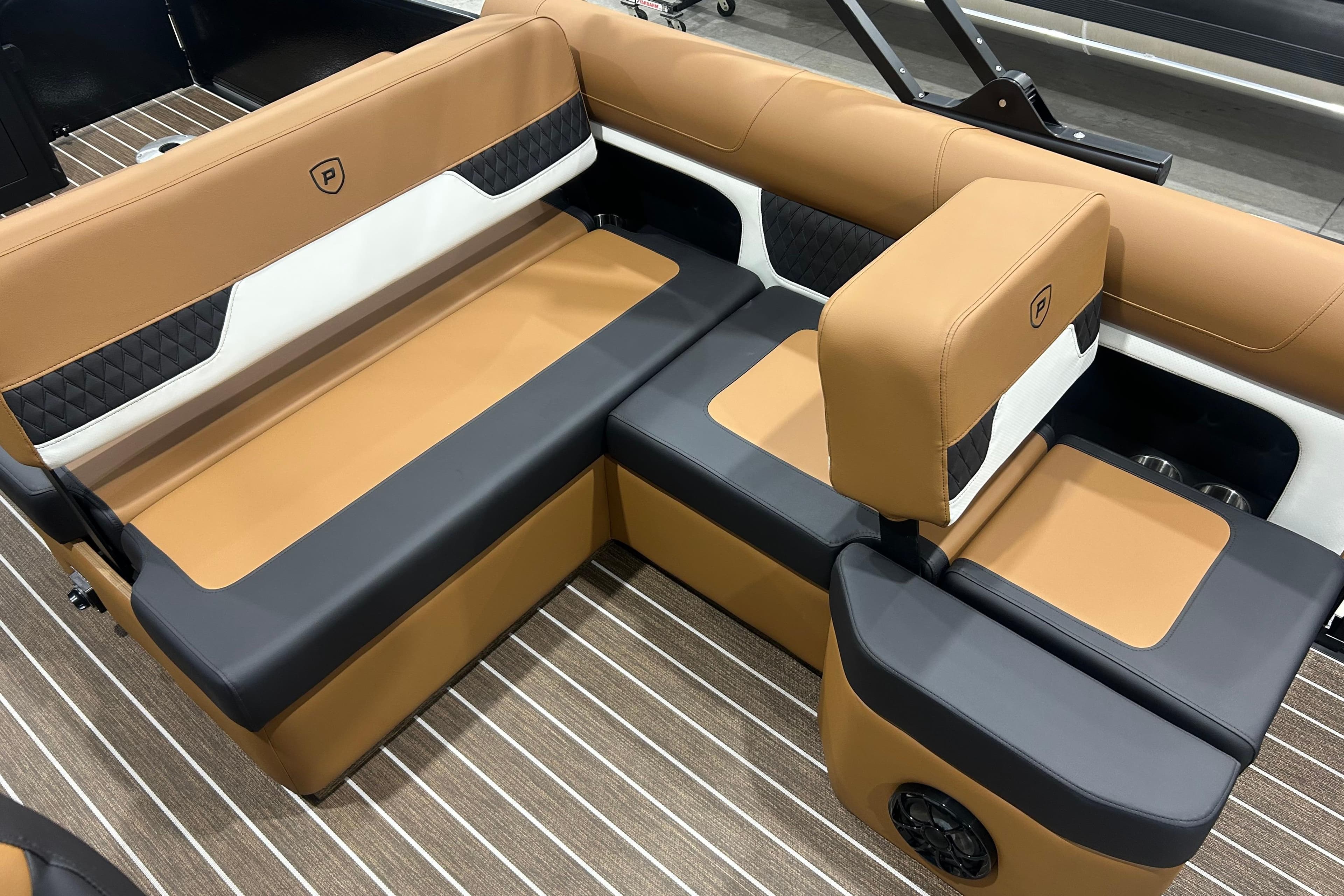 Luxurious seating in 2026 Premier 250 Solaris RS boat with tan and black upholstery.