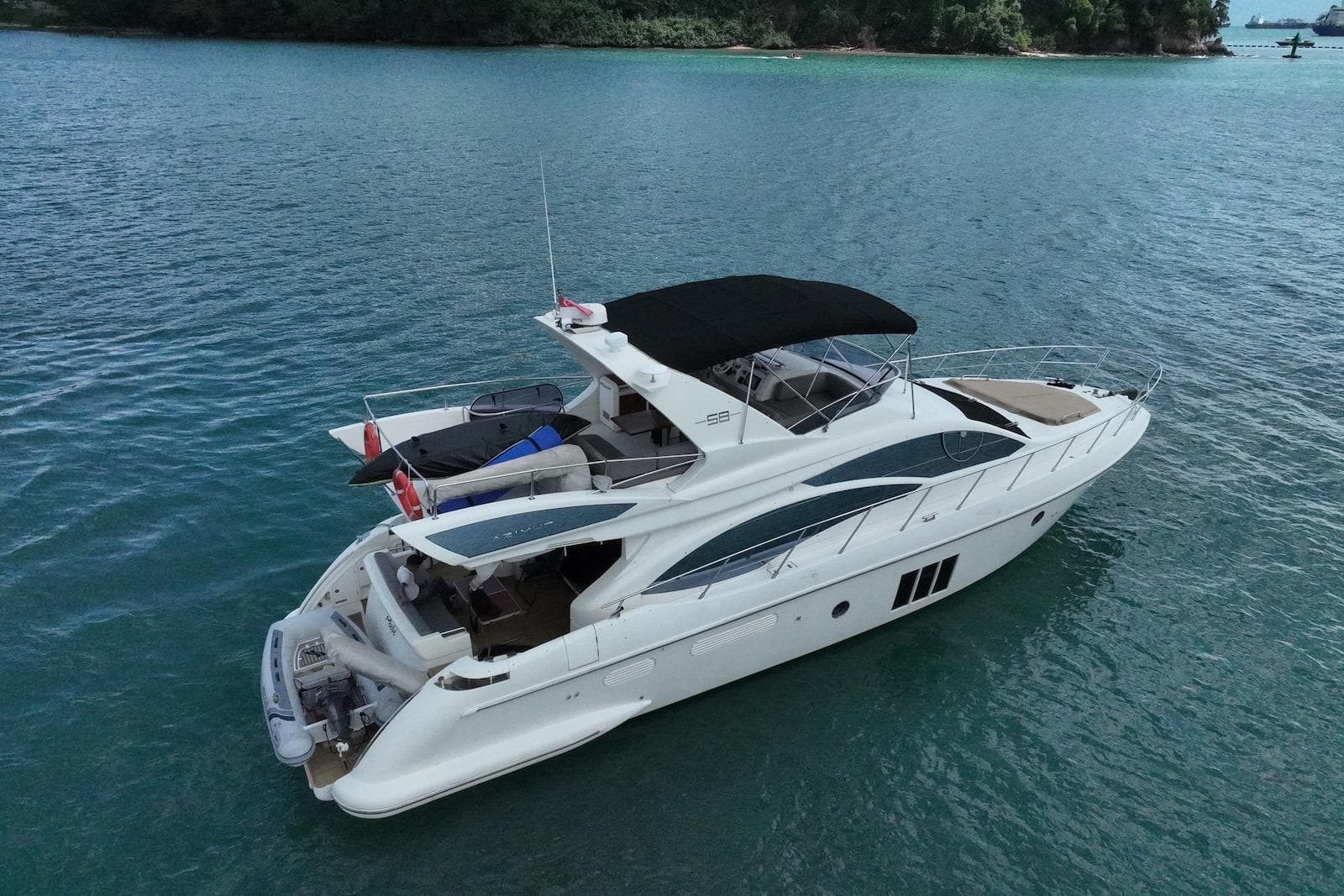 Luxury 2009 Azimut 58 yacht cruising on serene blue waters.