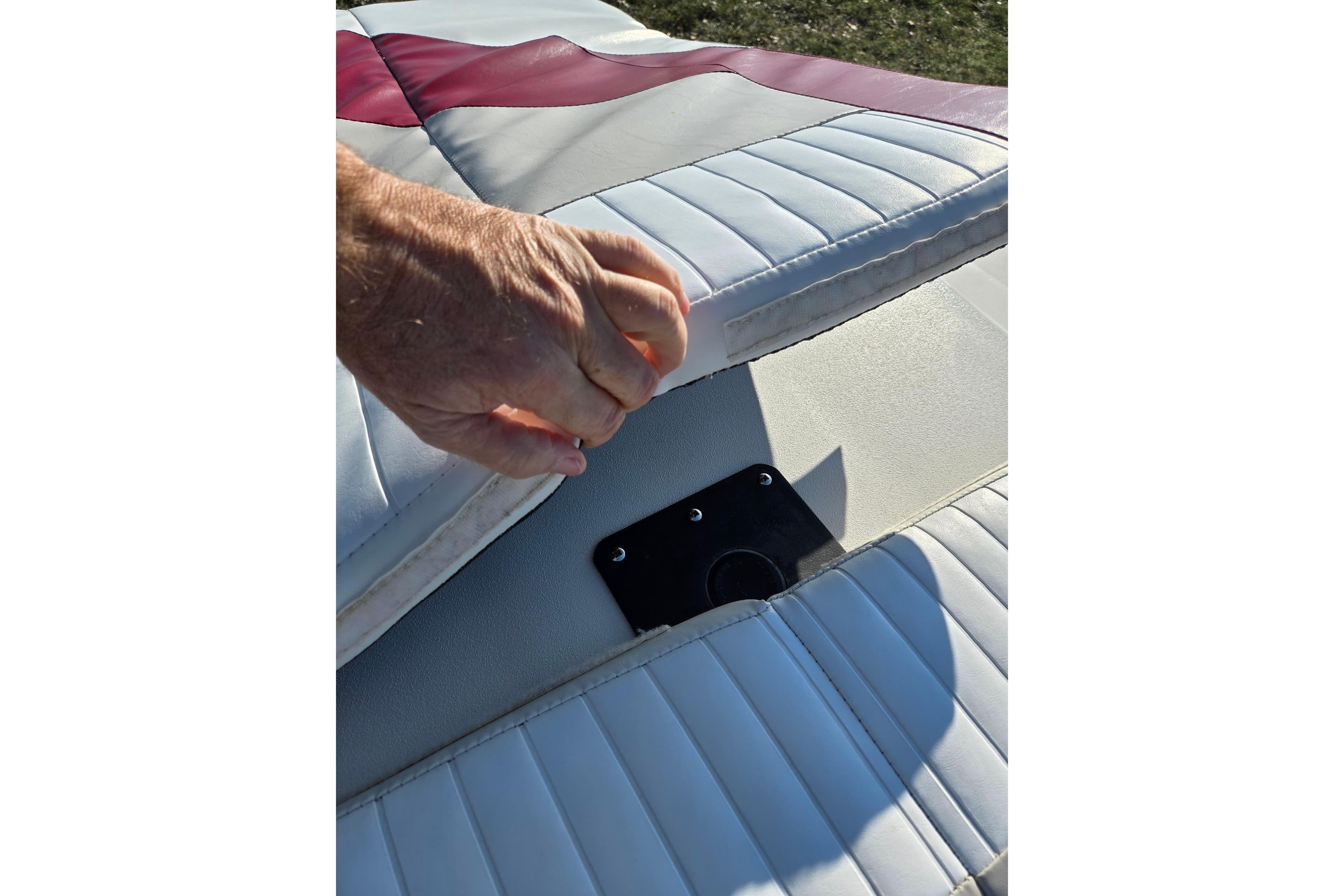 Hand lifting seat cushion on 2007 Glastron GT 205 Ski & Fish boat.