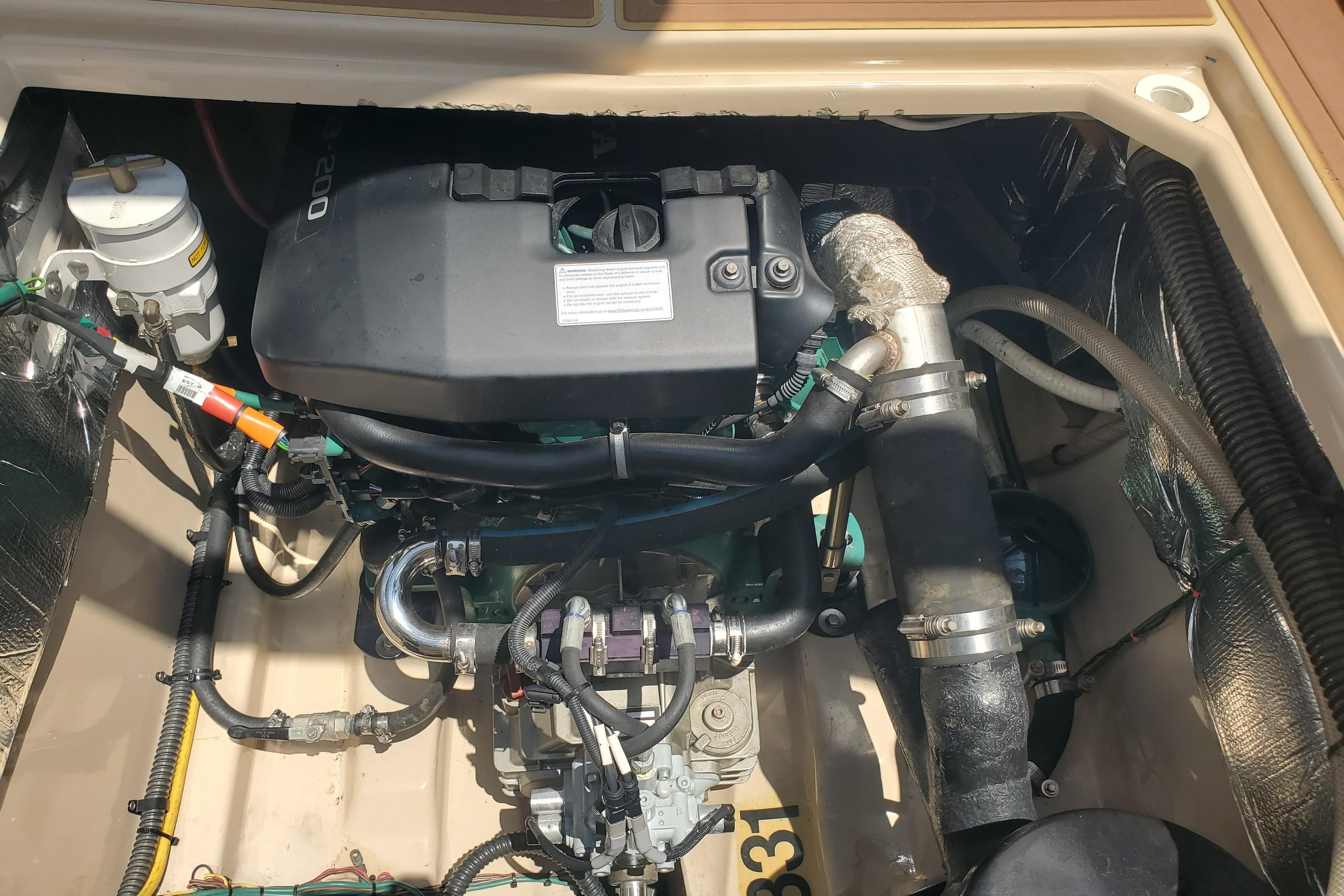 Engine compartment of a 2013 Cutwater 26 boat, showcasing detailed mechanical components.