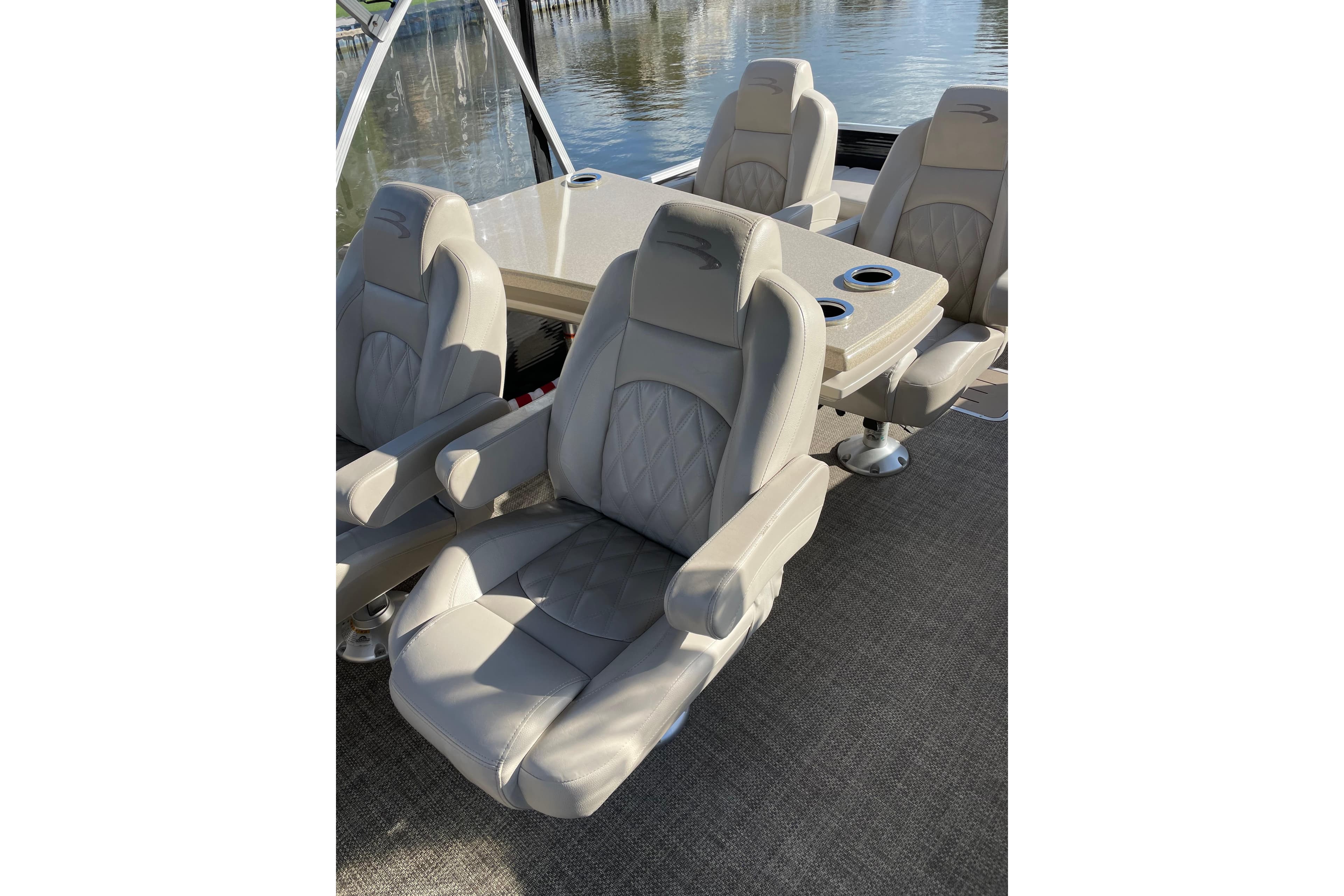 Luxurious seating on a 2015 Bennington 2575 QSD pontoon boat, featuring plush, beige upholstery.