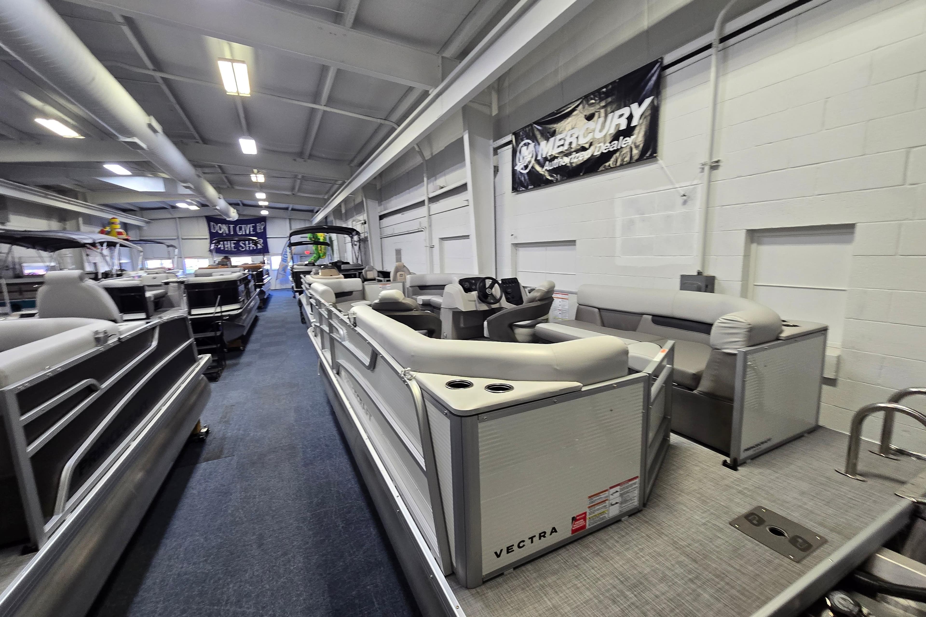 2026 Princecraft Vectra 21 QL pontoon boat displayed in a showroom.