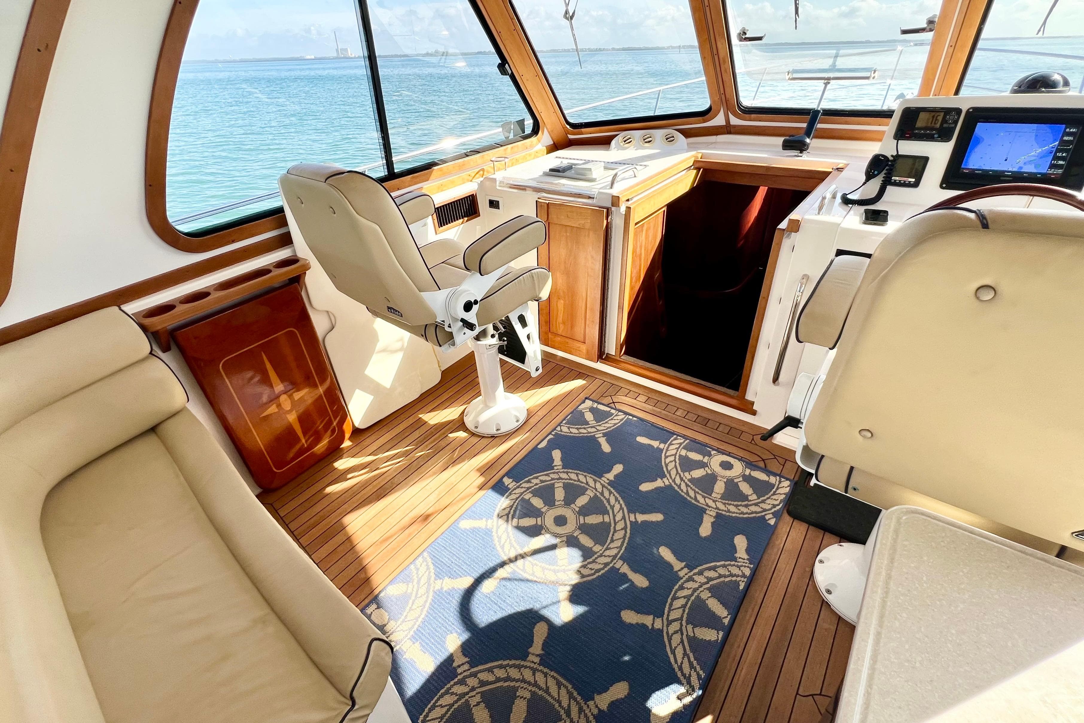 Interior of 2006 Sabre 38 Hard Top Express yacht with helm, seating, and nautical decor.