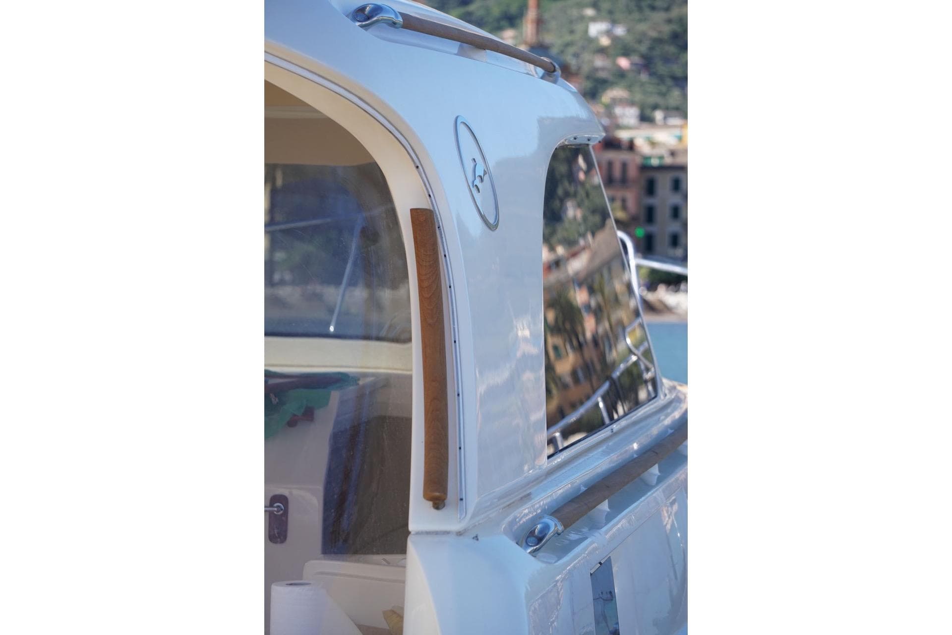 Close-up of a 2005 MOCHI 44 Dolphin yacht exterior with scenic reflections.