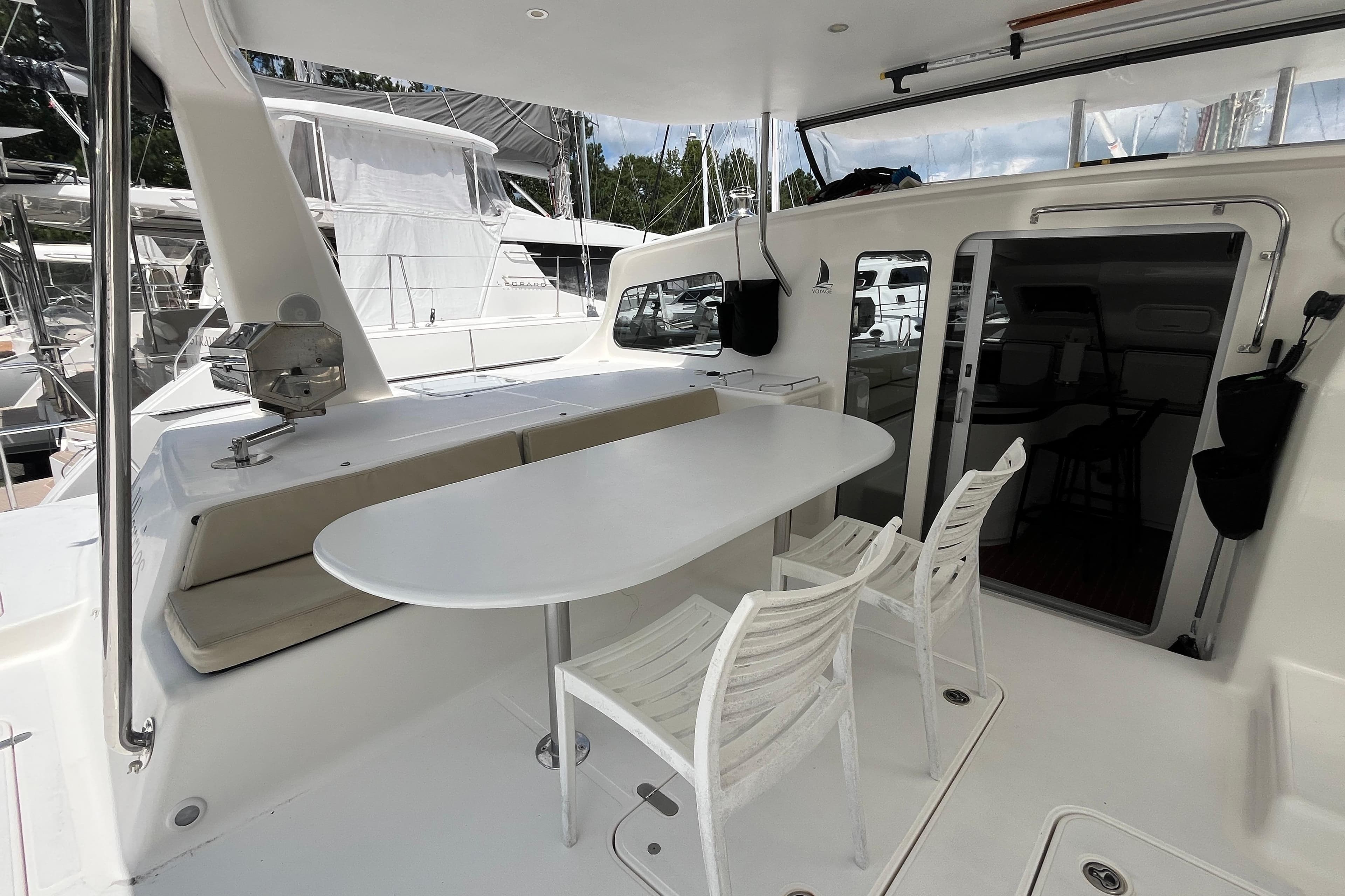 Spacious deck of 2013 Voyage Yachts 520 with seating and dining area.