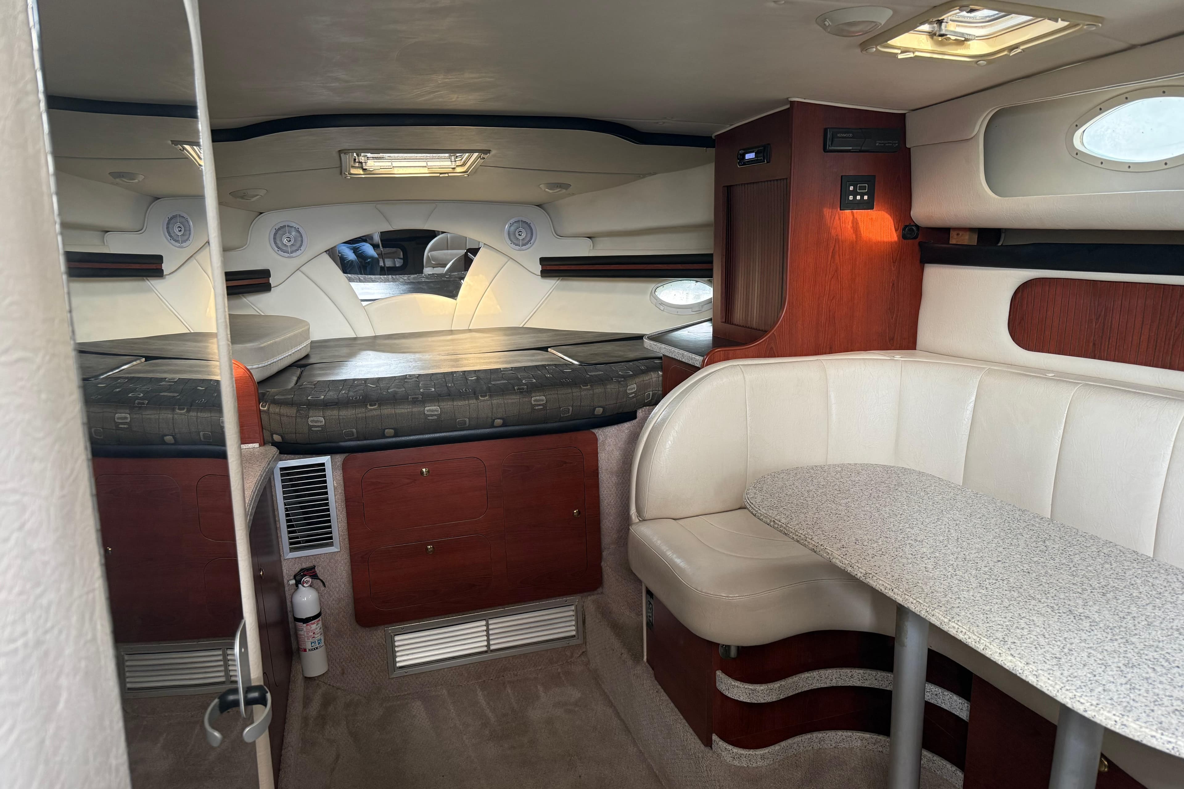 2002 Rinker Fiesta Vee 342 cabin interior with seating and sleeping area.