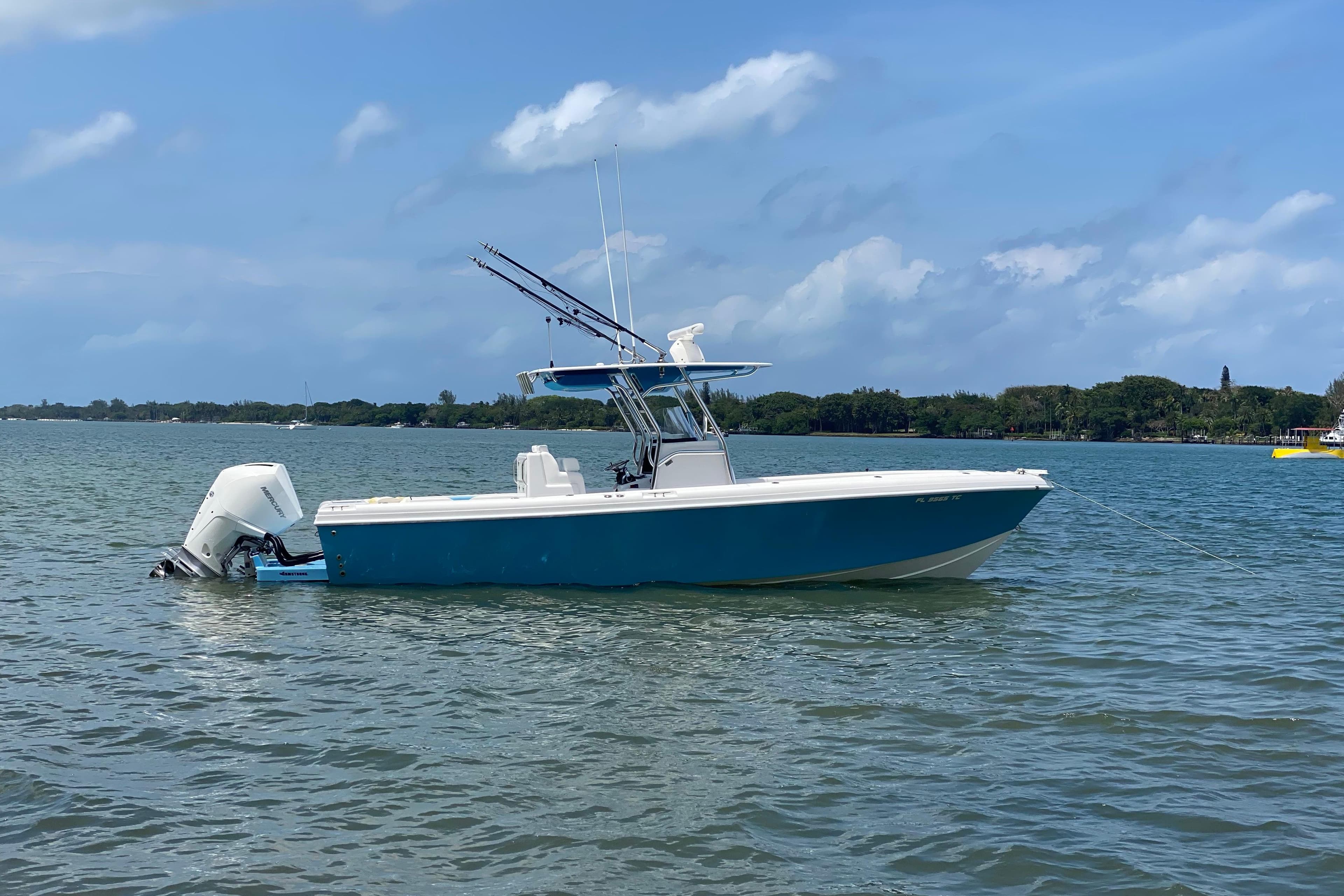 2022 Bluewater 2850 CC boat anchored on calm water under a clear blue sky.