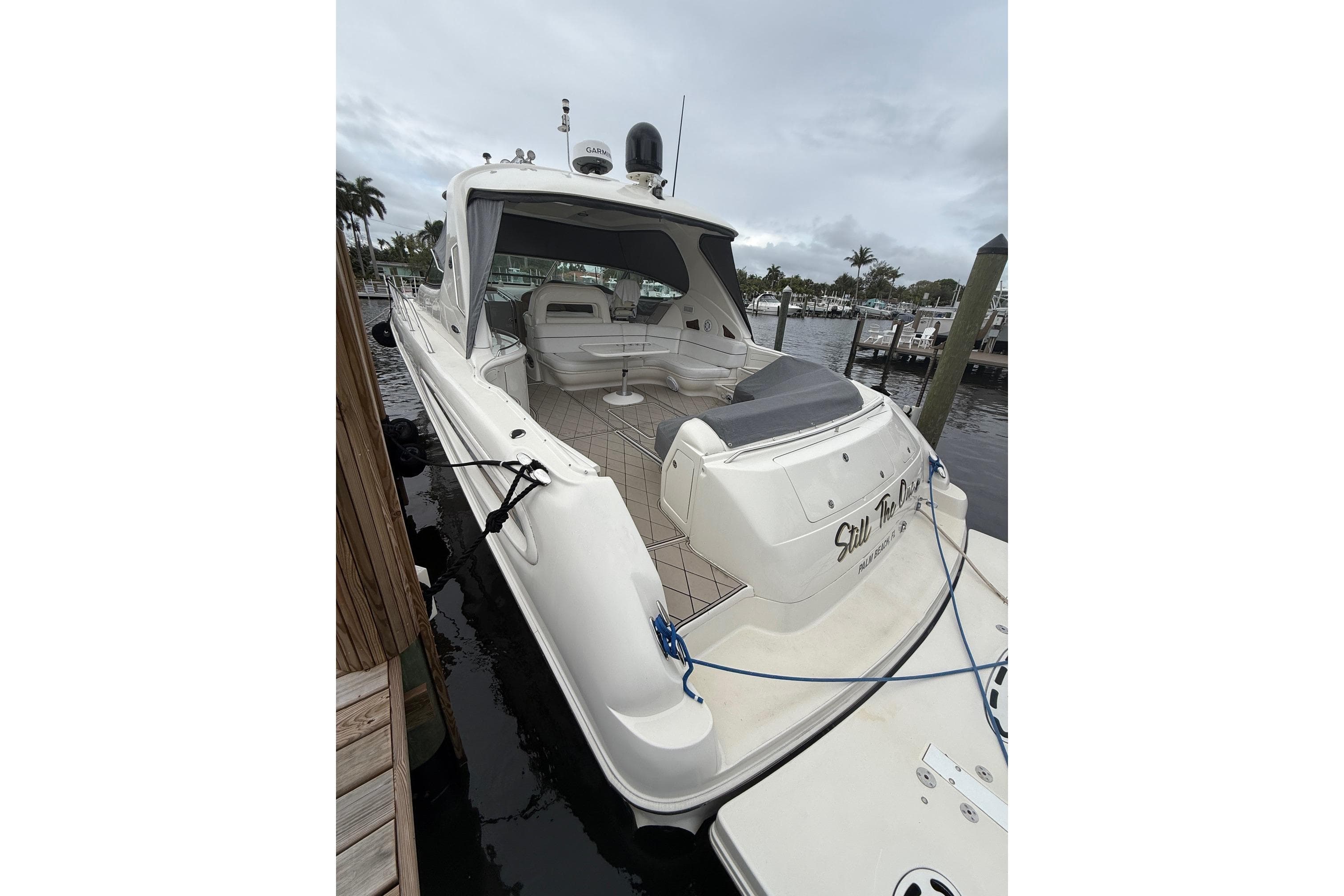 2004 Sea Ray 550 Sundancer yacht docked at marina, featuring spacious deck and seating area.