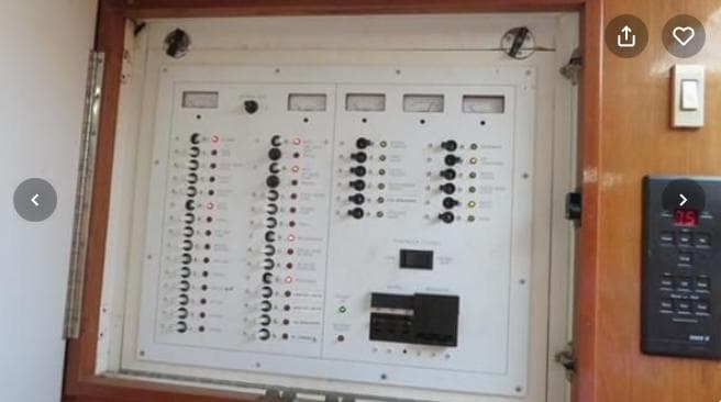 Electrical control panel on a 2001 Topaz Express boat, featuring multiple switches and meters.