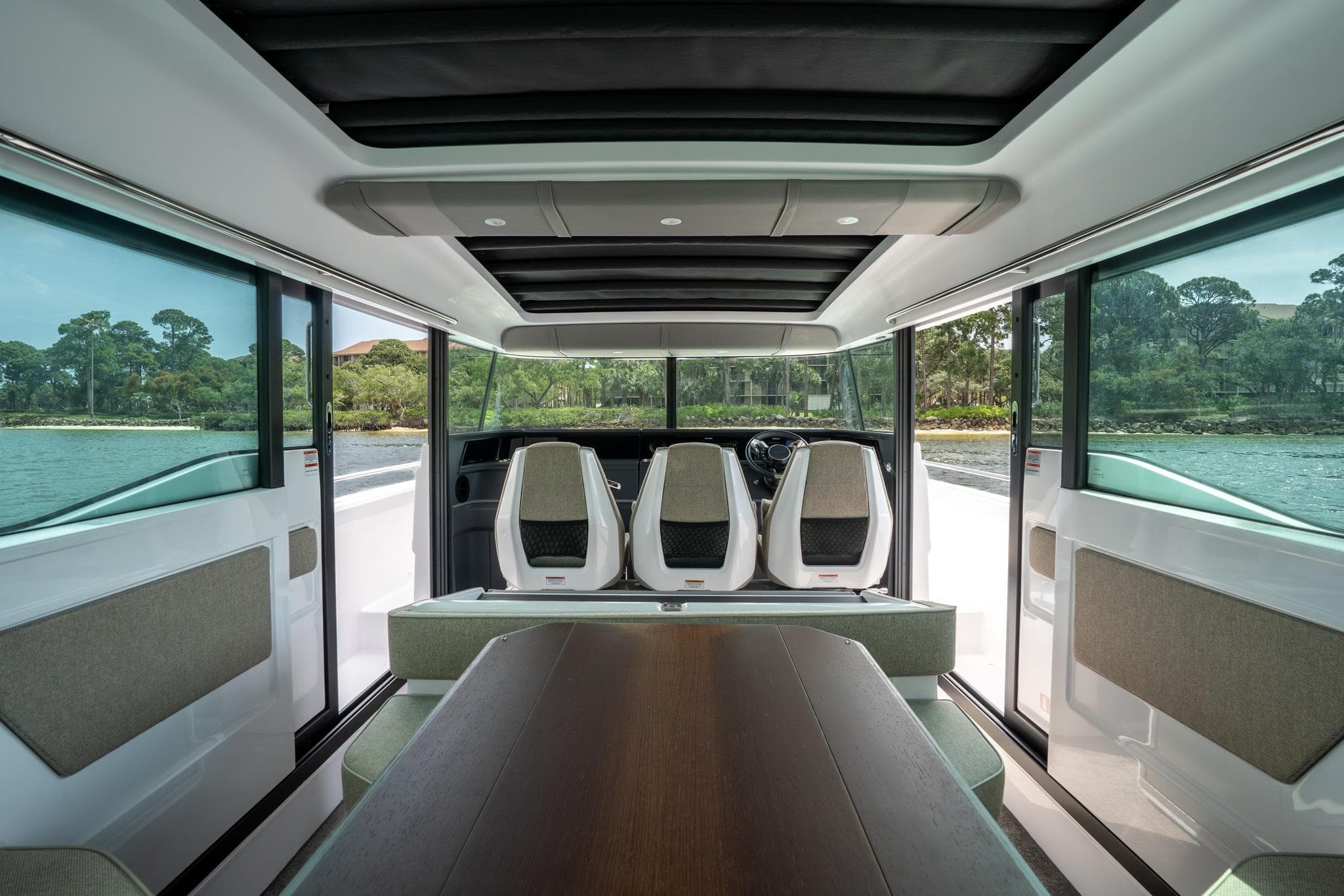 Interior of 2024 Axopar 45 XC Cross Cabin with panoramic windows and modern seating.