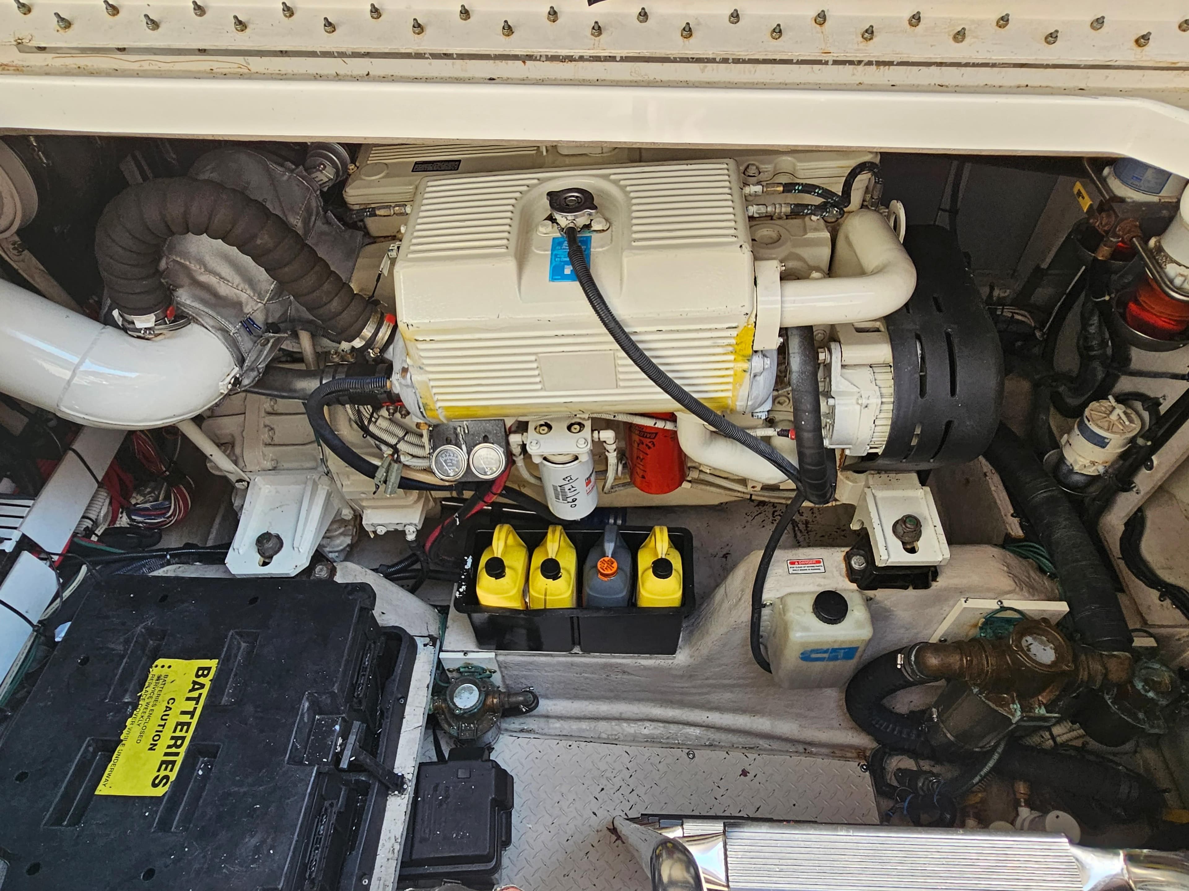 Engine compartment of a 2005 Sea Ray 48 Sundancer, showcasing batteries and mechanical components.