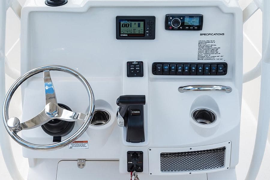 Manufacturer Provided Image: Control panel of a 2022 Sailfish 220 CC boat with steering wheel and electronic displays.