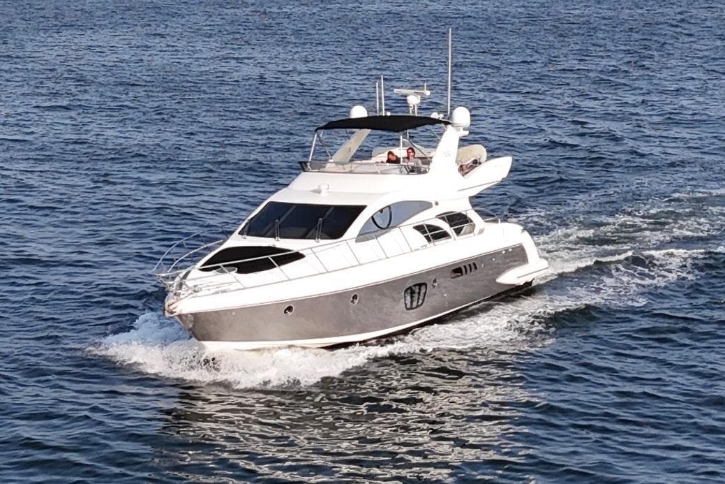 Luxury 2010 Azimut 55E yacht cruising on open water.