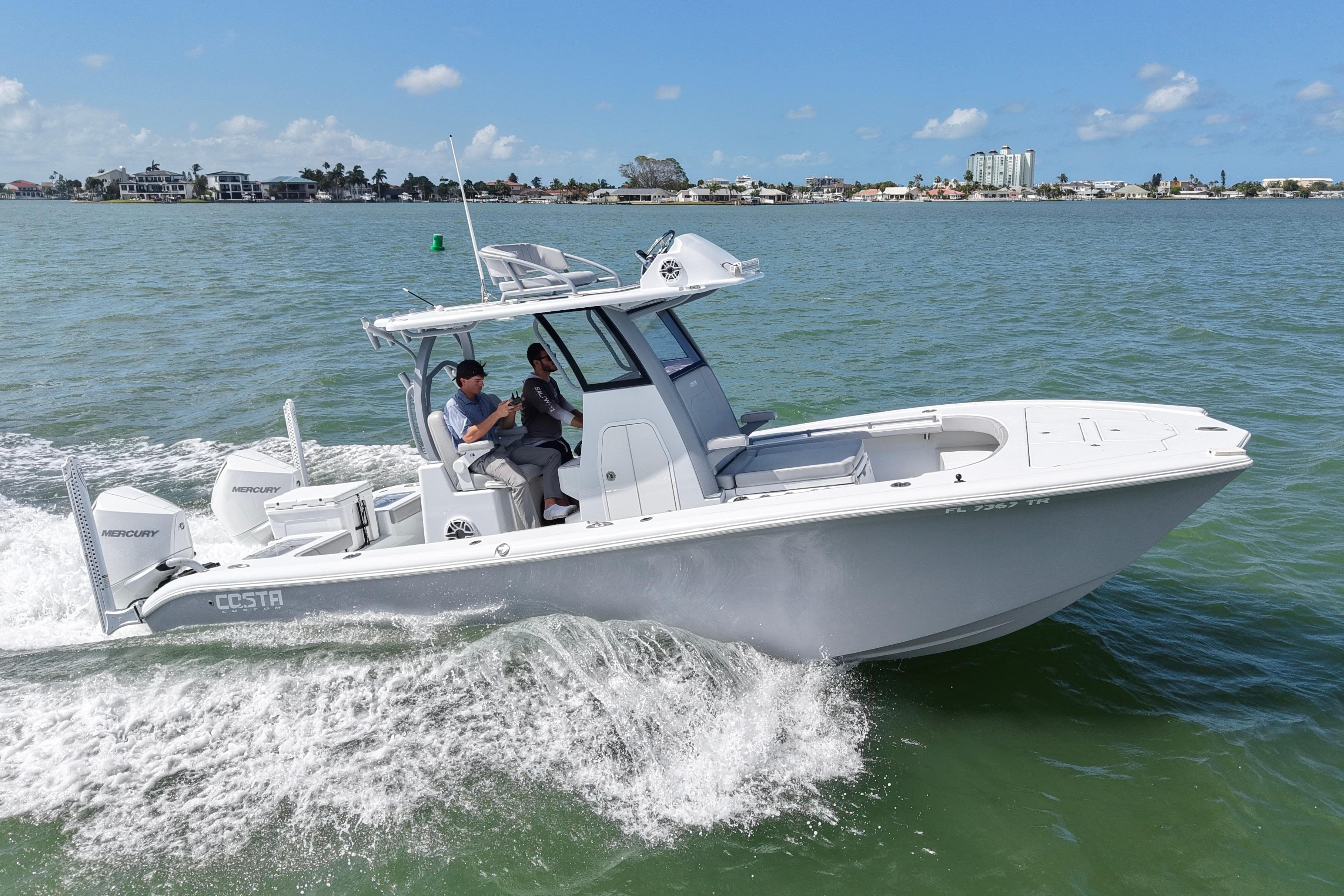 2024 Costa Custom Boats 264HC cruising on open water under clear skies.