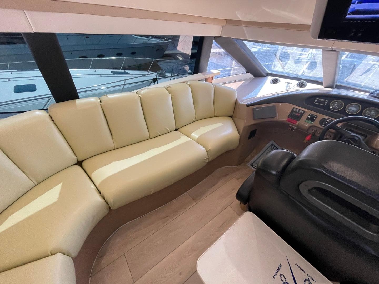 Interior of 1998 Carver 530 Voyager Pilothouse with beige seating and helm controls.