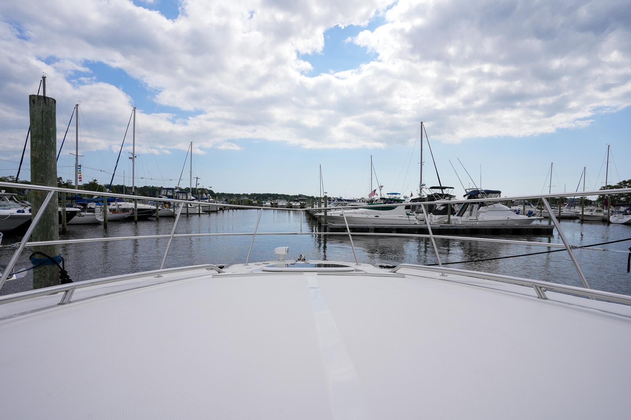 View from the bow of a 2010 Sea Ray 500 Sundancer in a marina.