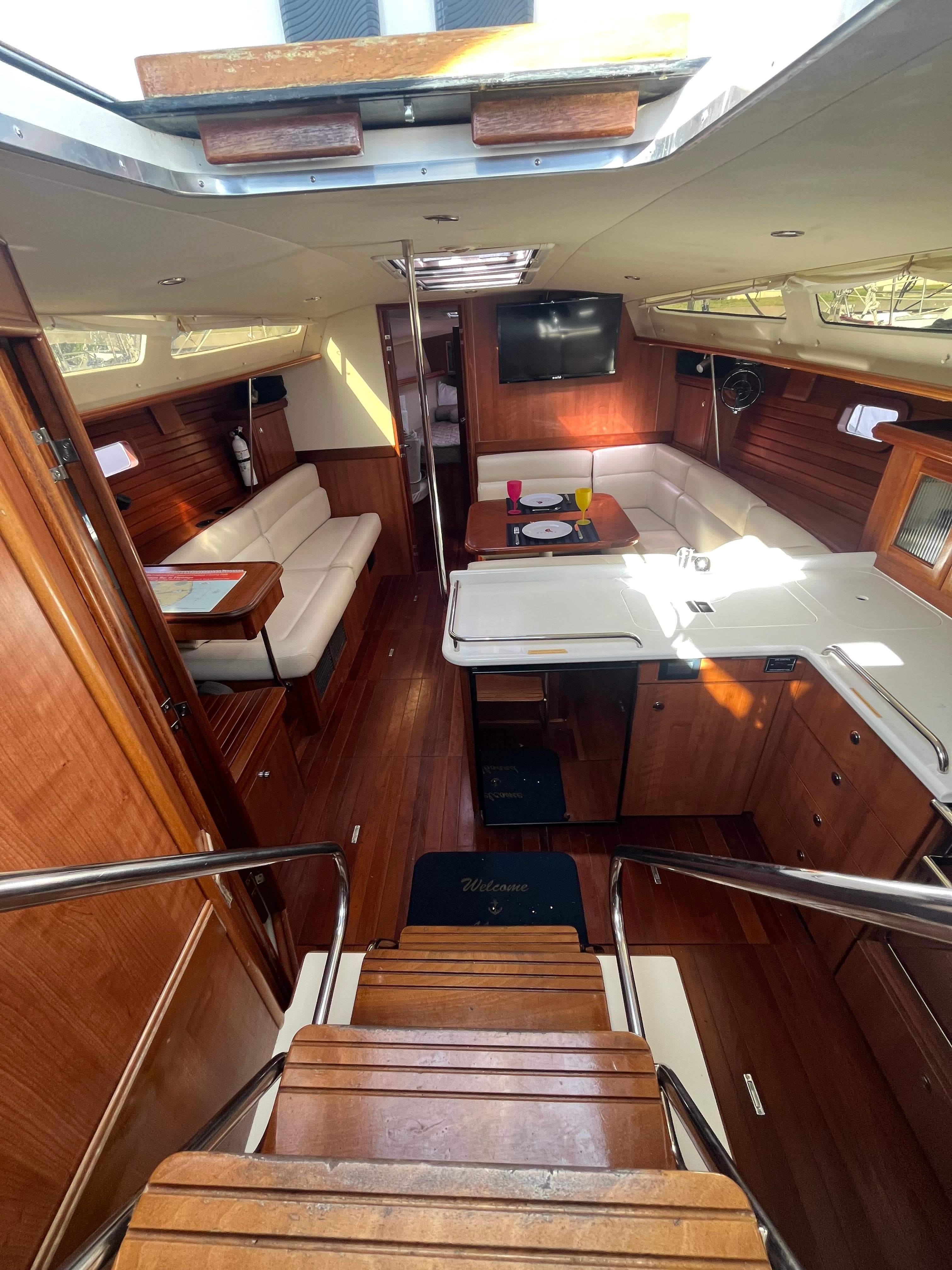 Interior of 2015 Marlow-Hunter 40 yacht with wood finish and cozy seating area.