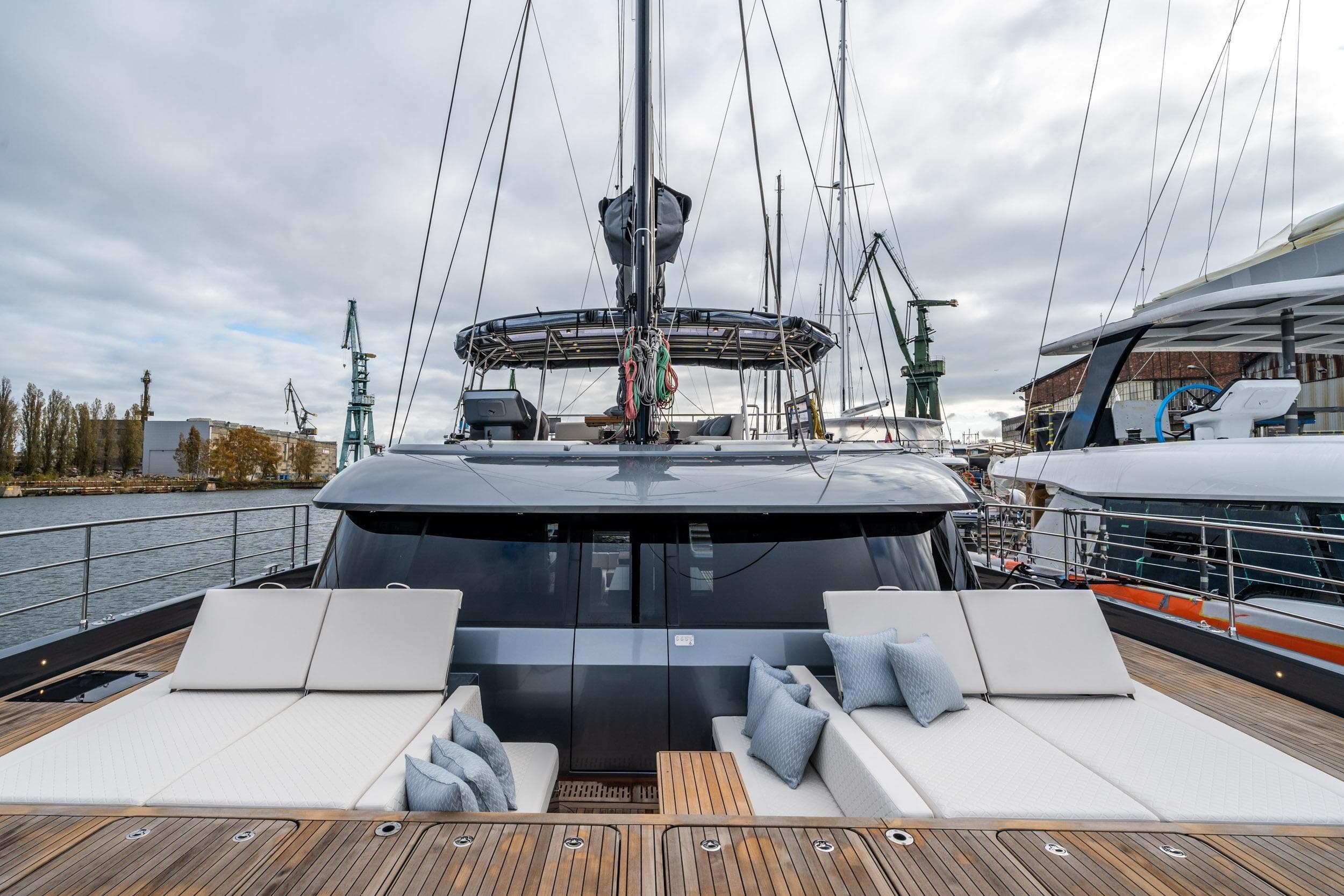Luxurious 2023 Sunreef 50 yacht with spacious deck and modern design in marina setting.