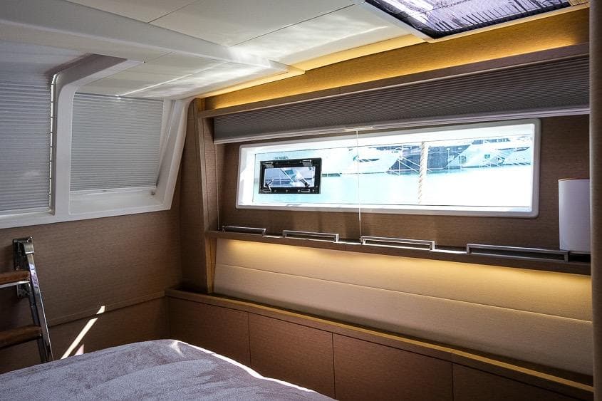 Luxurious interior of 2020 Lagoon 630 MY yacht cabin with modern design and window view.
