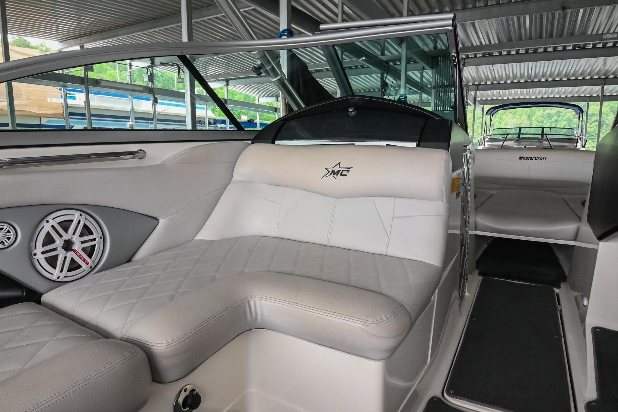 2009 MasterCraft X-45 boat interior with white leather seating and speaker system.