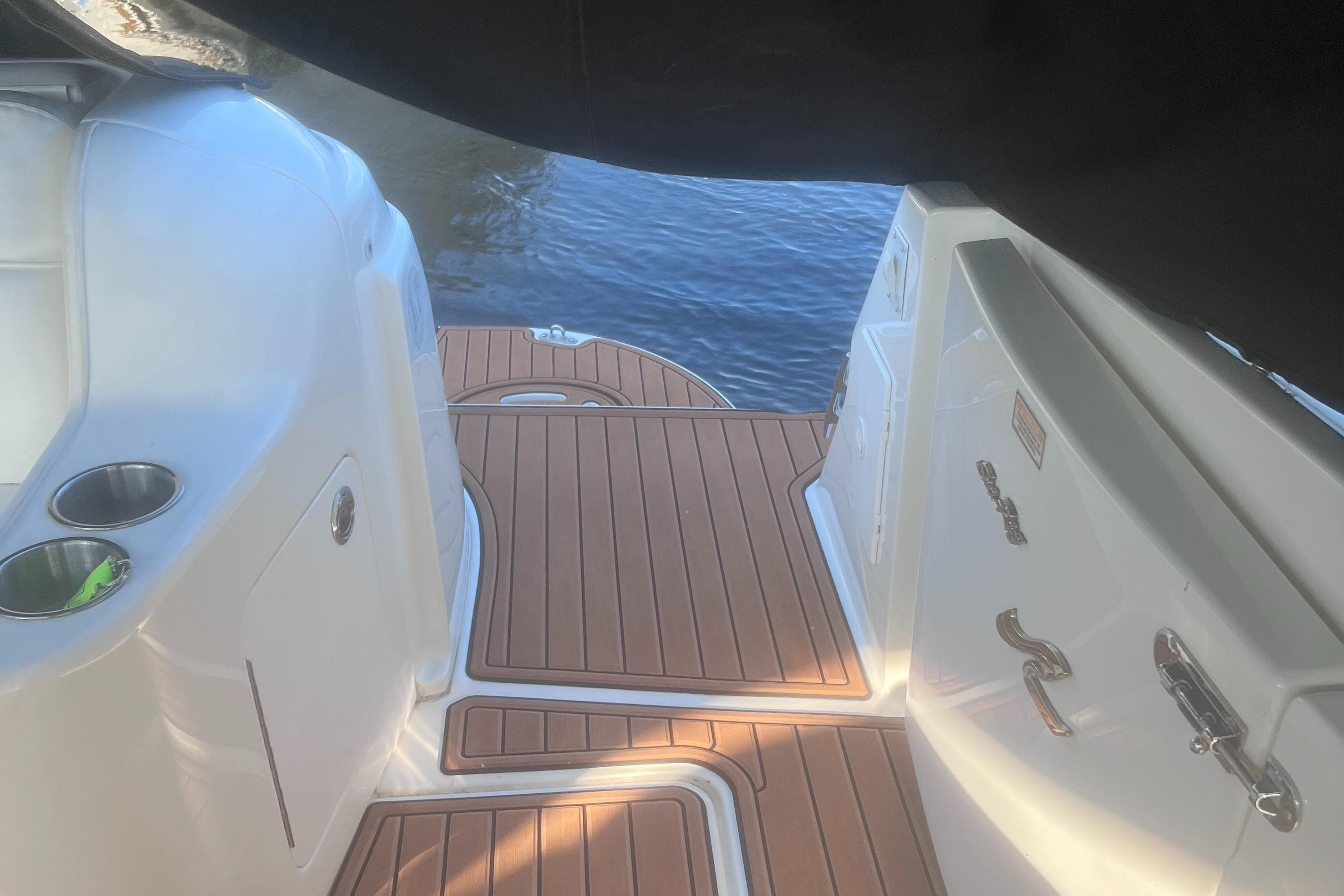 Sea Ray 460 Sundancer 2000 boat deck with wood finish, docked by the water.