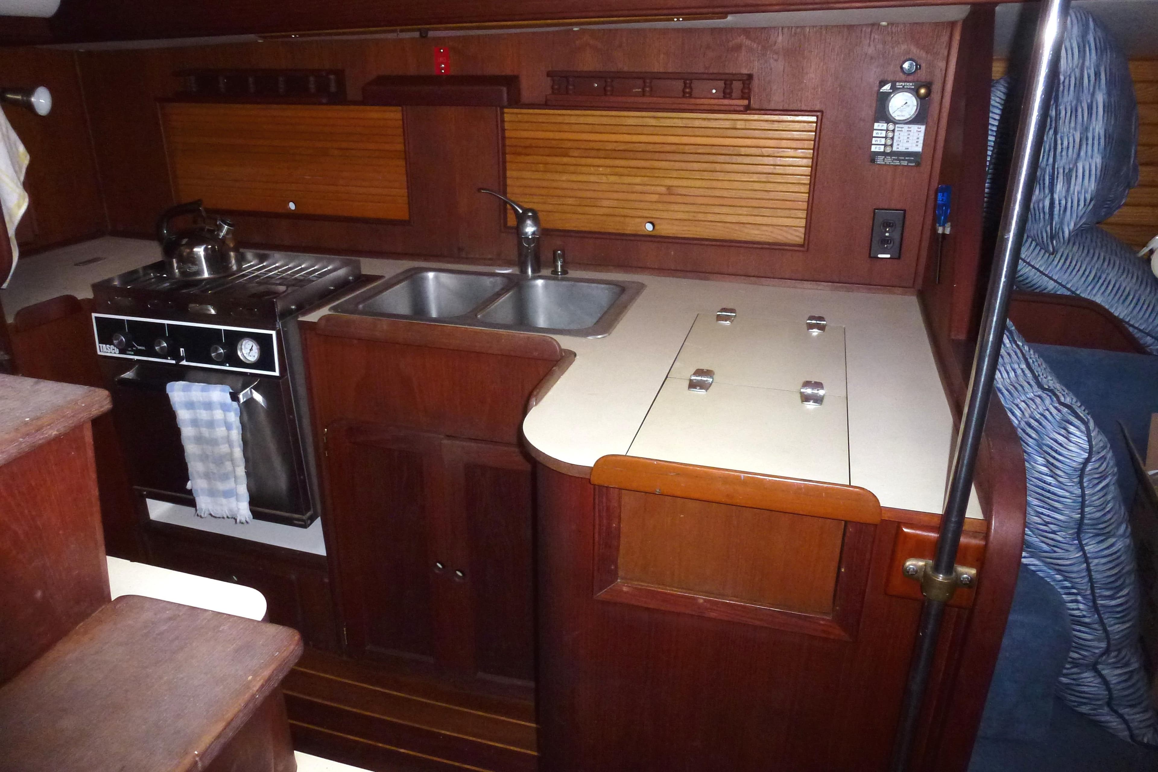 1984 Morgan 454 yacht interior kitchen with wooden cabinetry.