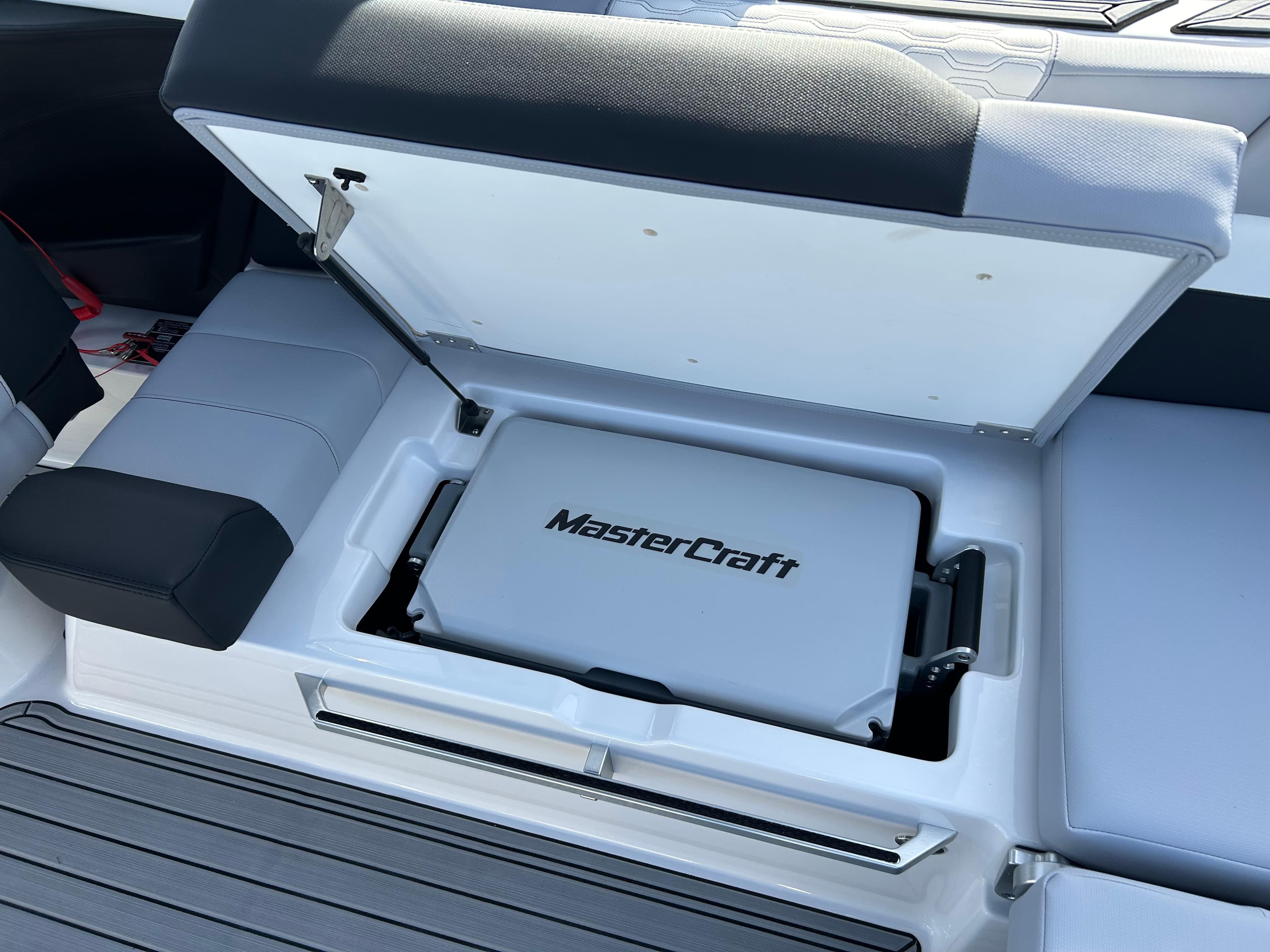 2024 MasterCraft XT22 boat storage compartment with MasterCraft logo.