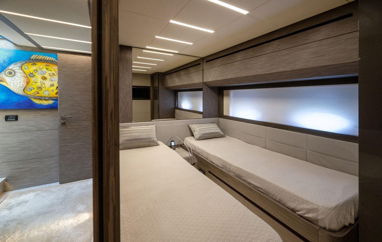 Luxurious 2019 Pershing 82 yacht cabin with twin beds and modern decor.