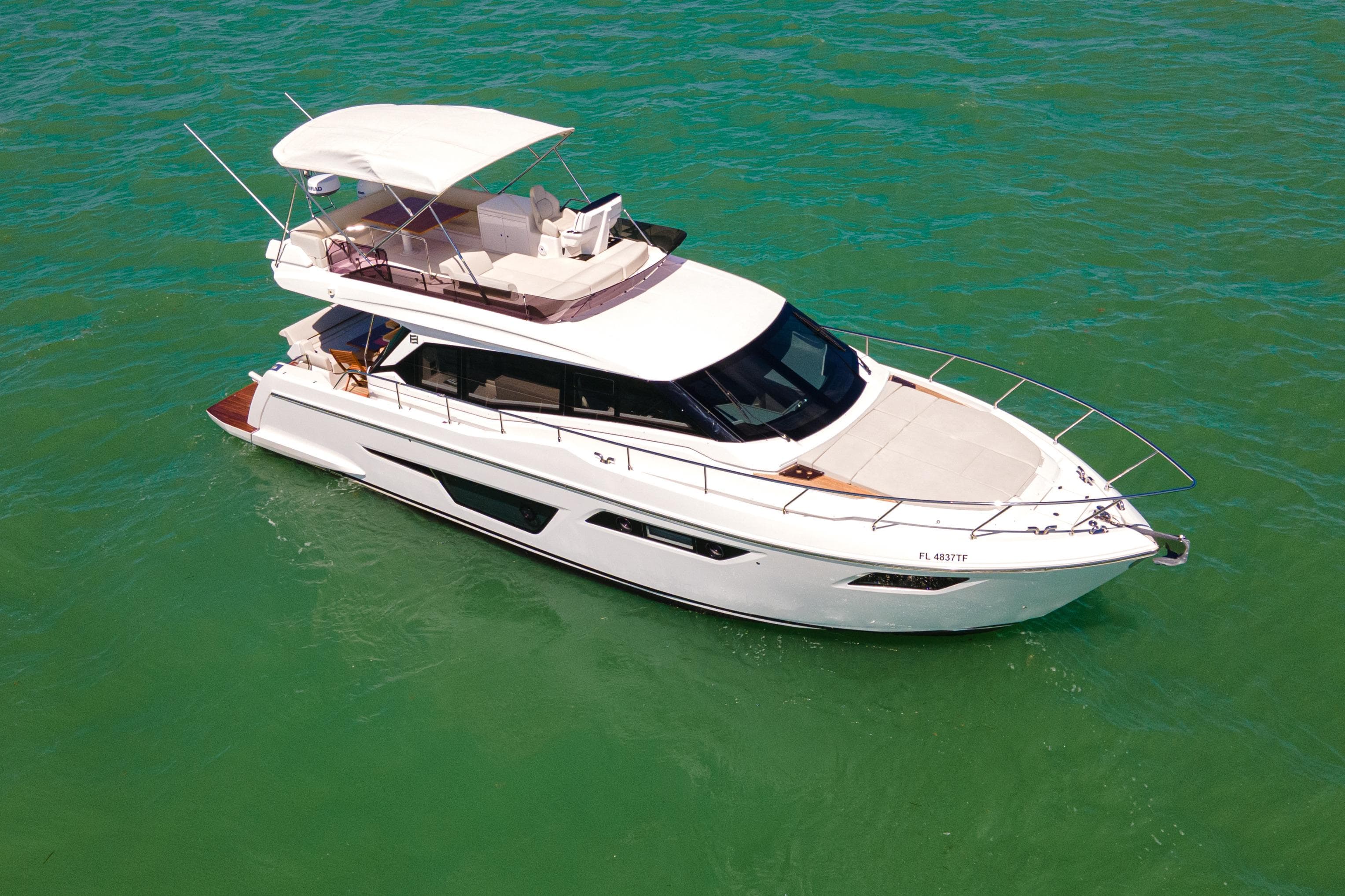 2022 Ferretti Yachts 500 cruising on clear turquoise waters.