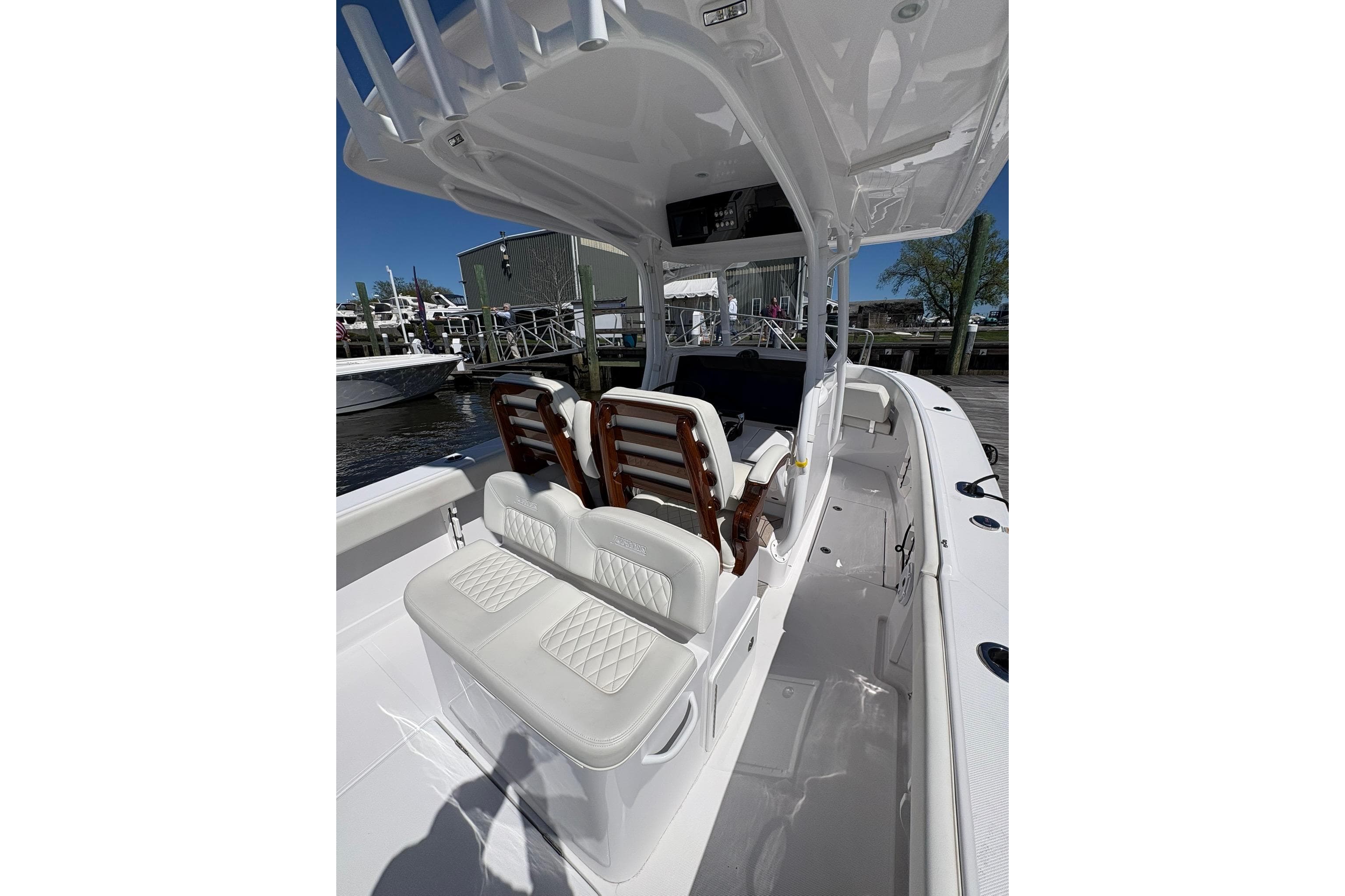 2023 Jupiter 30 boat interior with white seating and helm station.