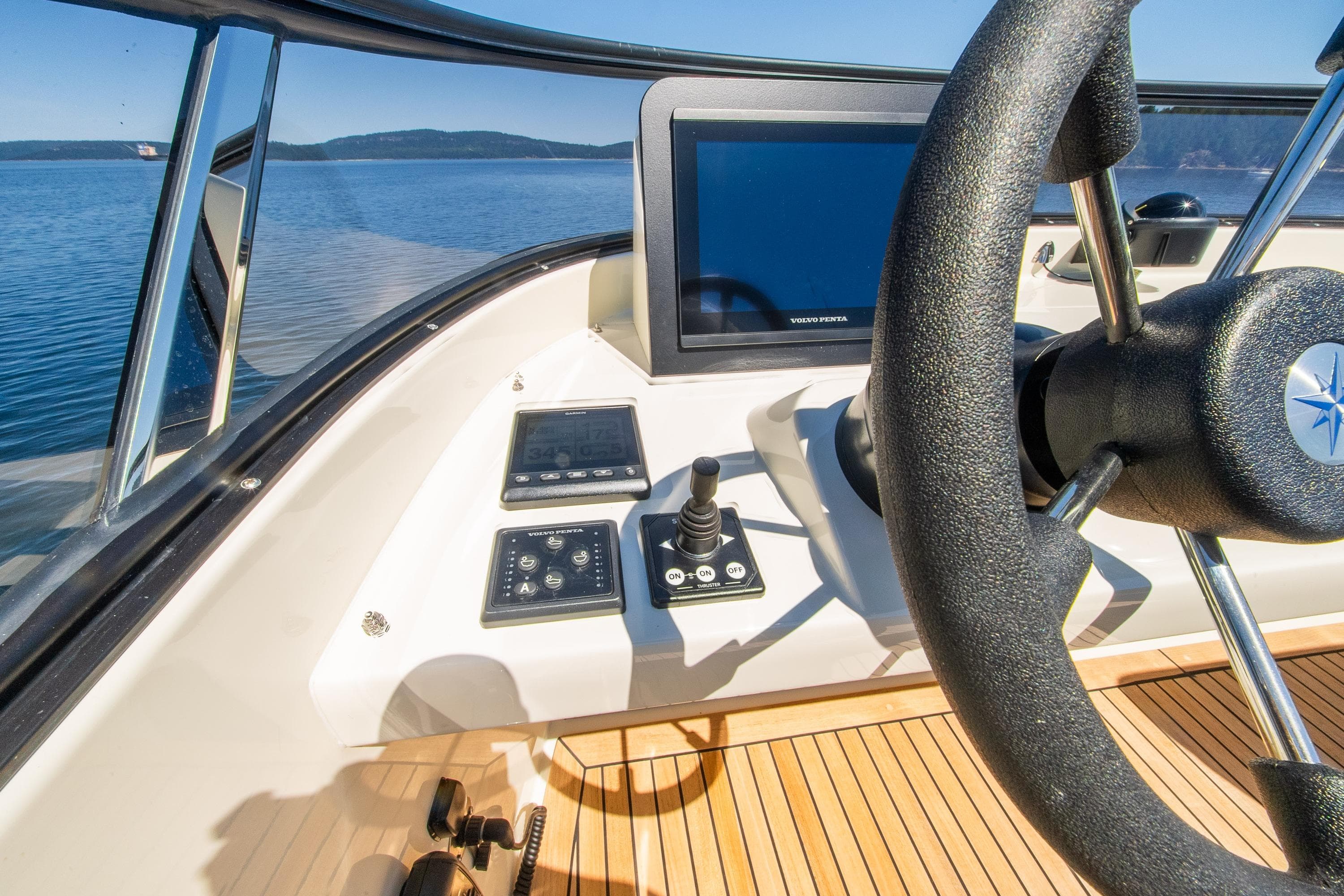 Steering console of 2026 Targa 41 boat with modern controls and scenic water view.