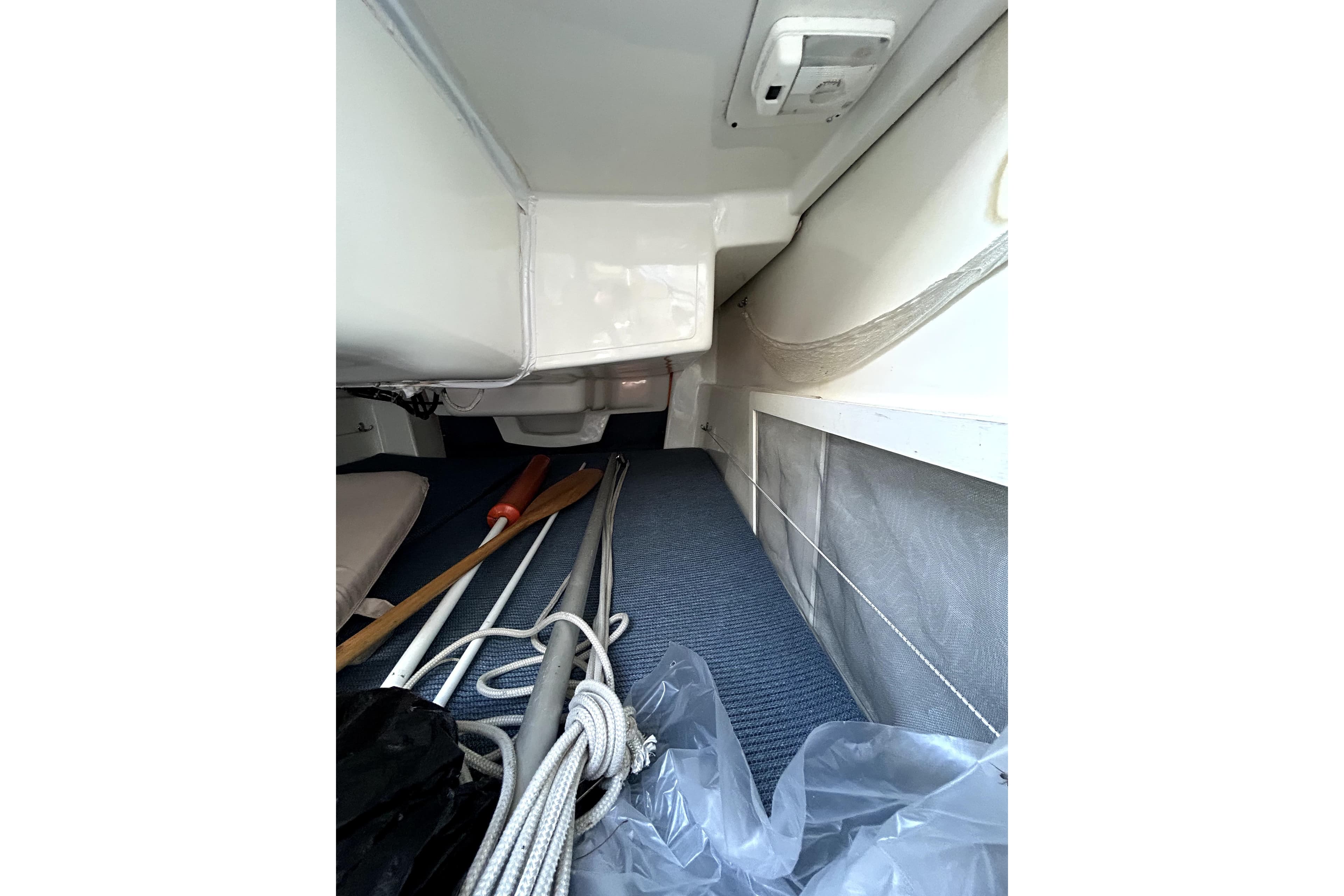 Interior view of 1998 MacGregor 26X Powersailer with ropes and paddles.