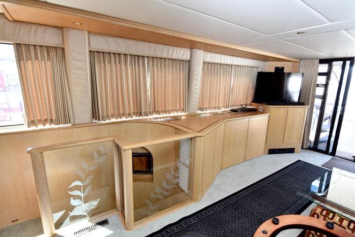Luxurious interior of 1997 Forbes Cooper 74 Pilothouse yacht with elegant wood finishes.