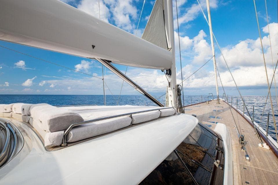 Luxurious Nautor Swan 112 RS yacht sailing on open sea under blue sky, 2000 model.