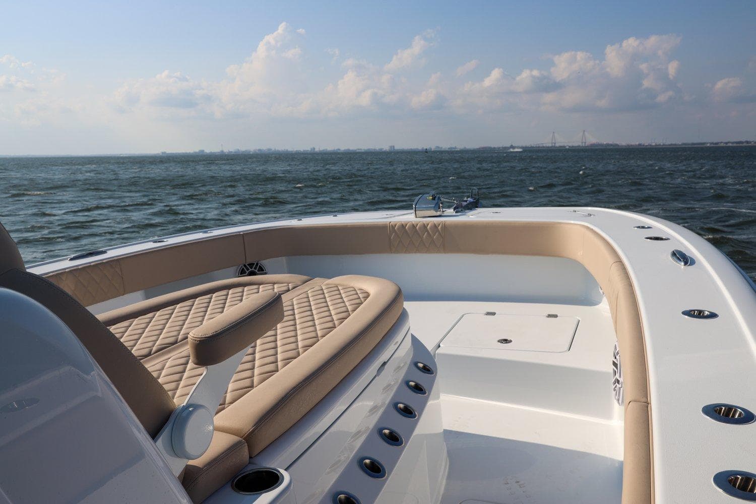 Freeman 35 boat, 2026 model, cruising on open water under a partly cloudy sky.